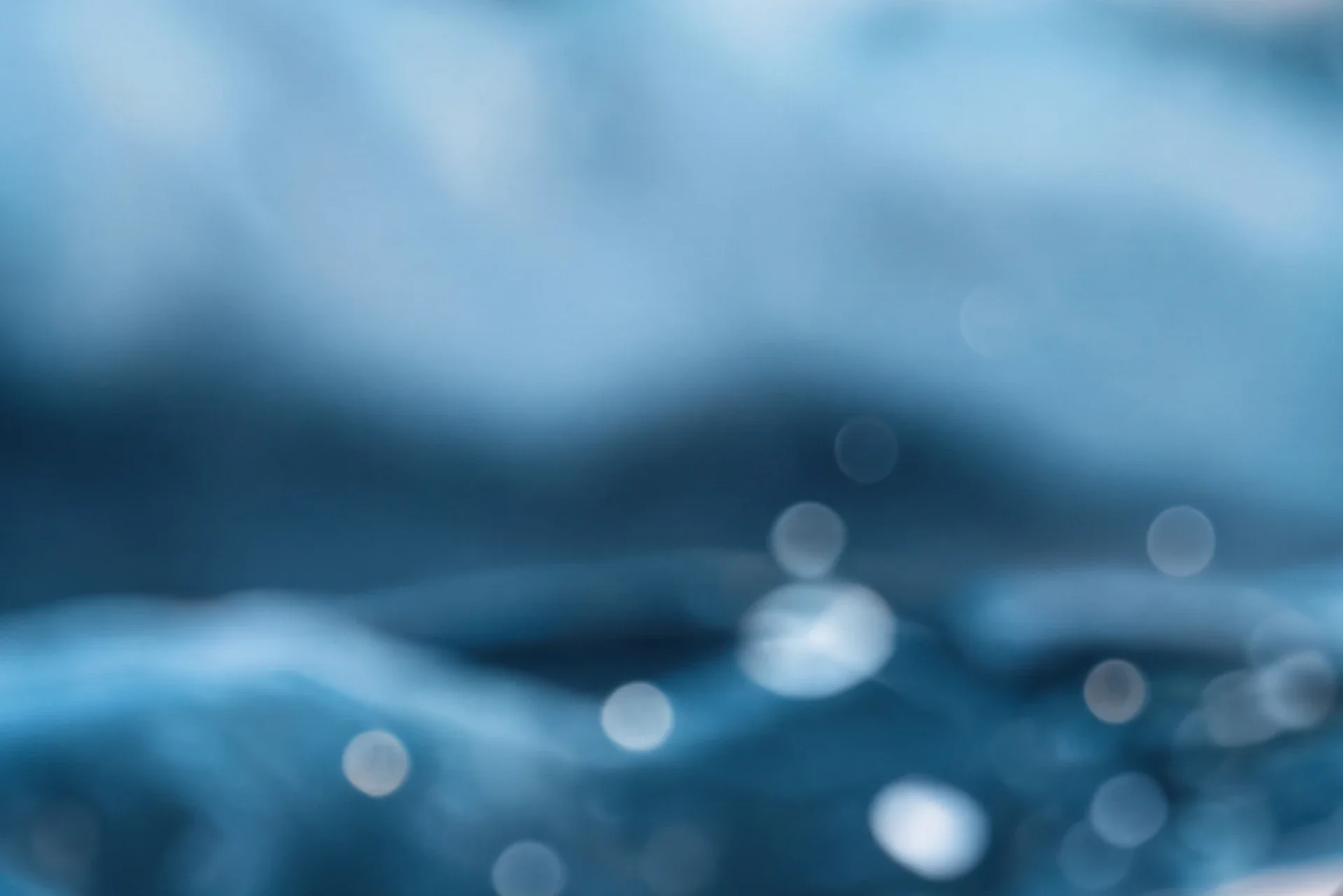 Tiefenunscharf otografierte Lichtreflexe auf dem Wasser