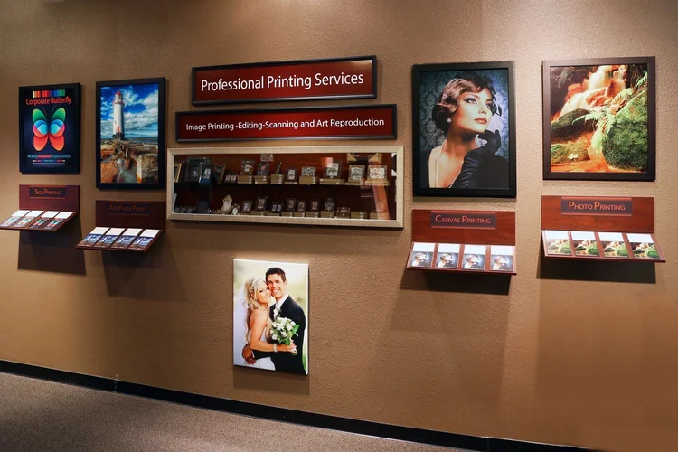 Printing display wall inside The Frame Gallery in San Antonio with canvas, photo and art paper print samples