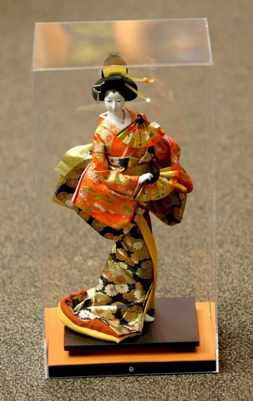 Japanese kimono doll in a custom acrylic display box on a wood base, built by The Frame Gallery