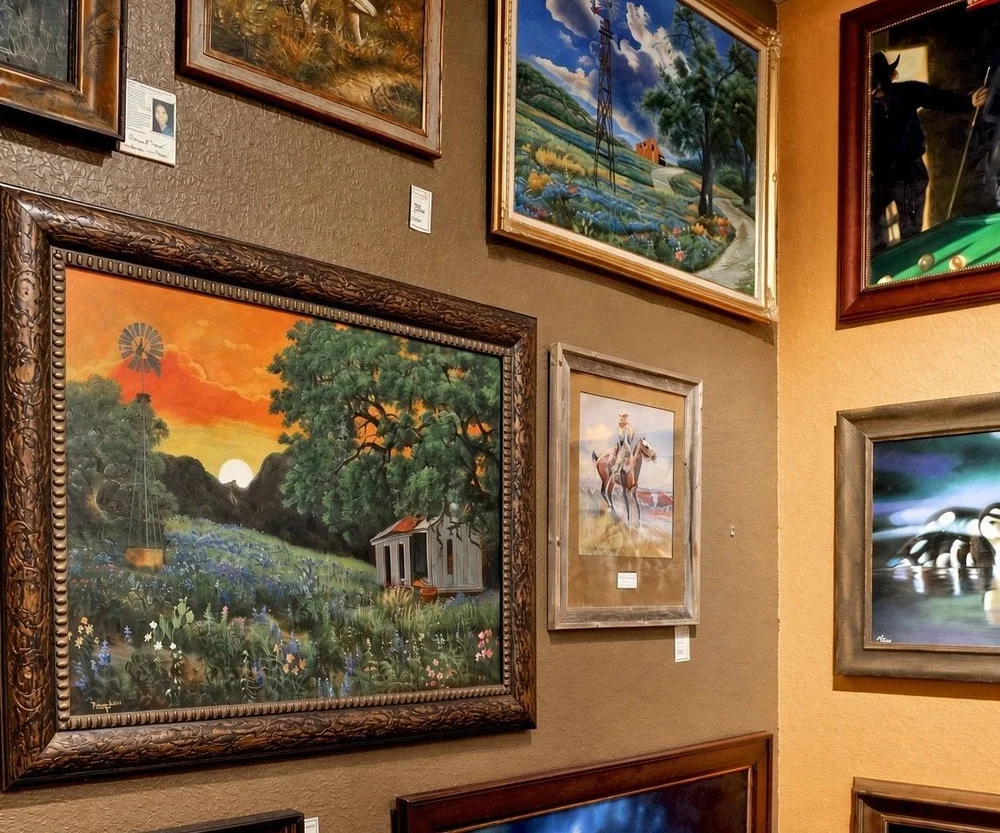 Original bluebonnet and windmill paintings of the Texas Hill Country on a gallery wall