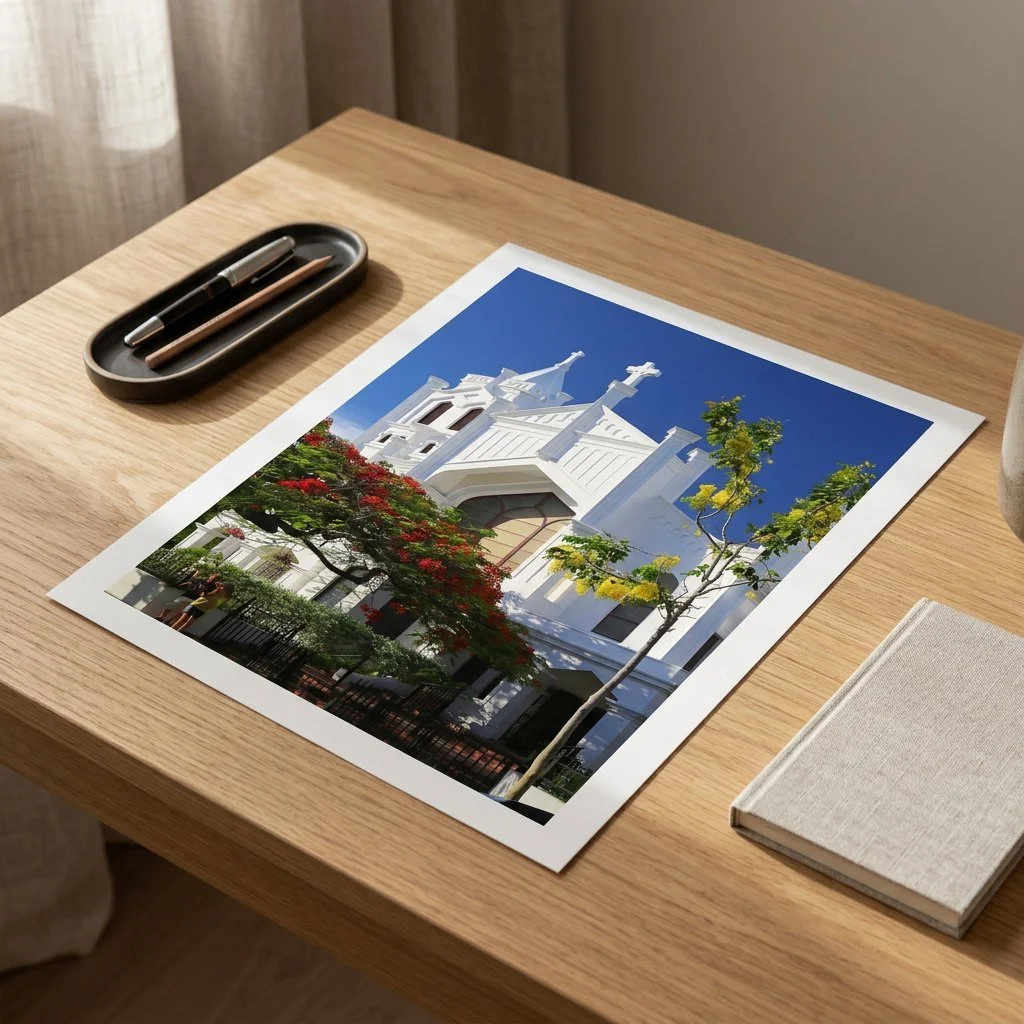 Photo print of a white Spanish-style church with red flowers under a blue sky