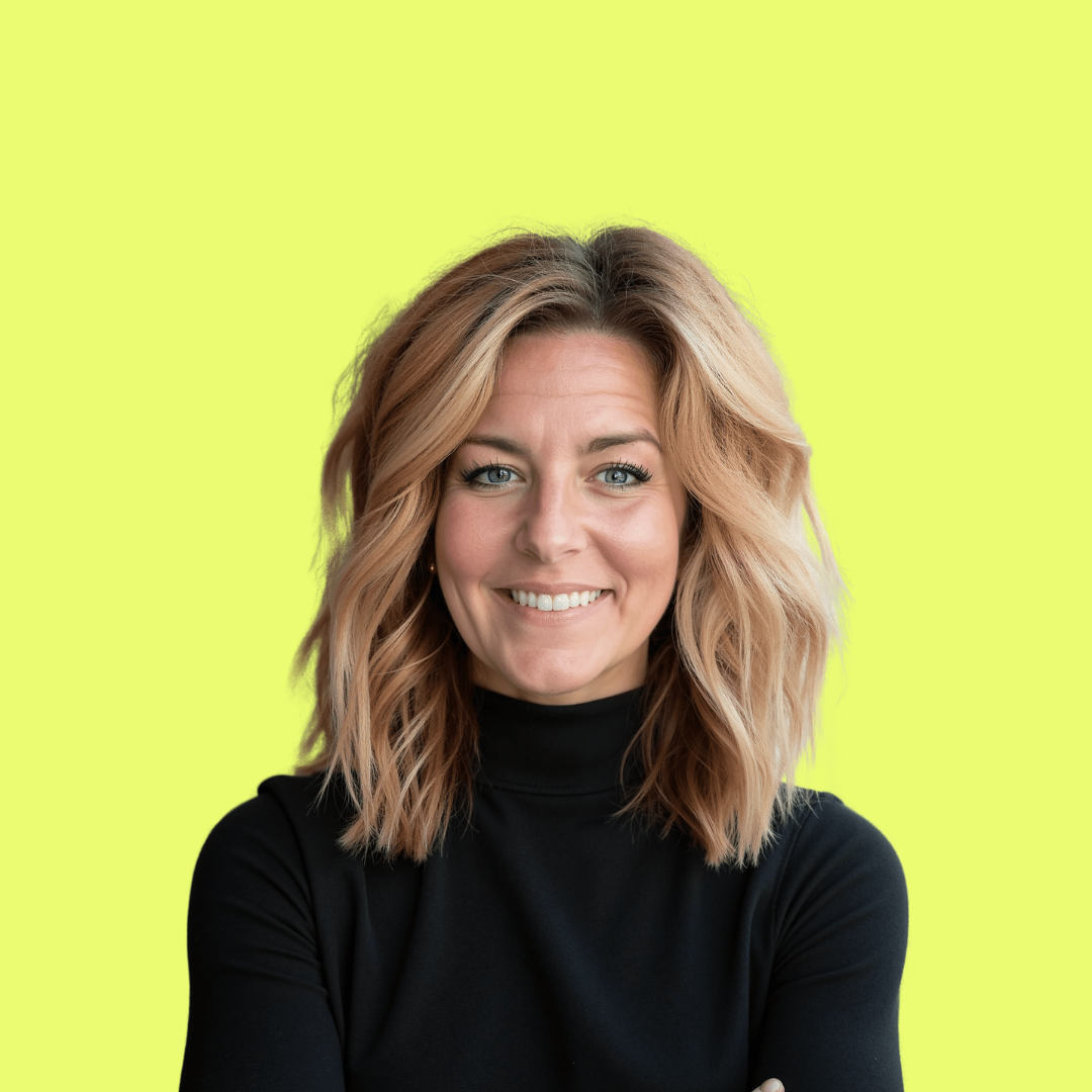Portrait of a smiling woman with shoulder-length wavy blonde hair wearing a black turtleneck sweater against a bright yellow background.