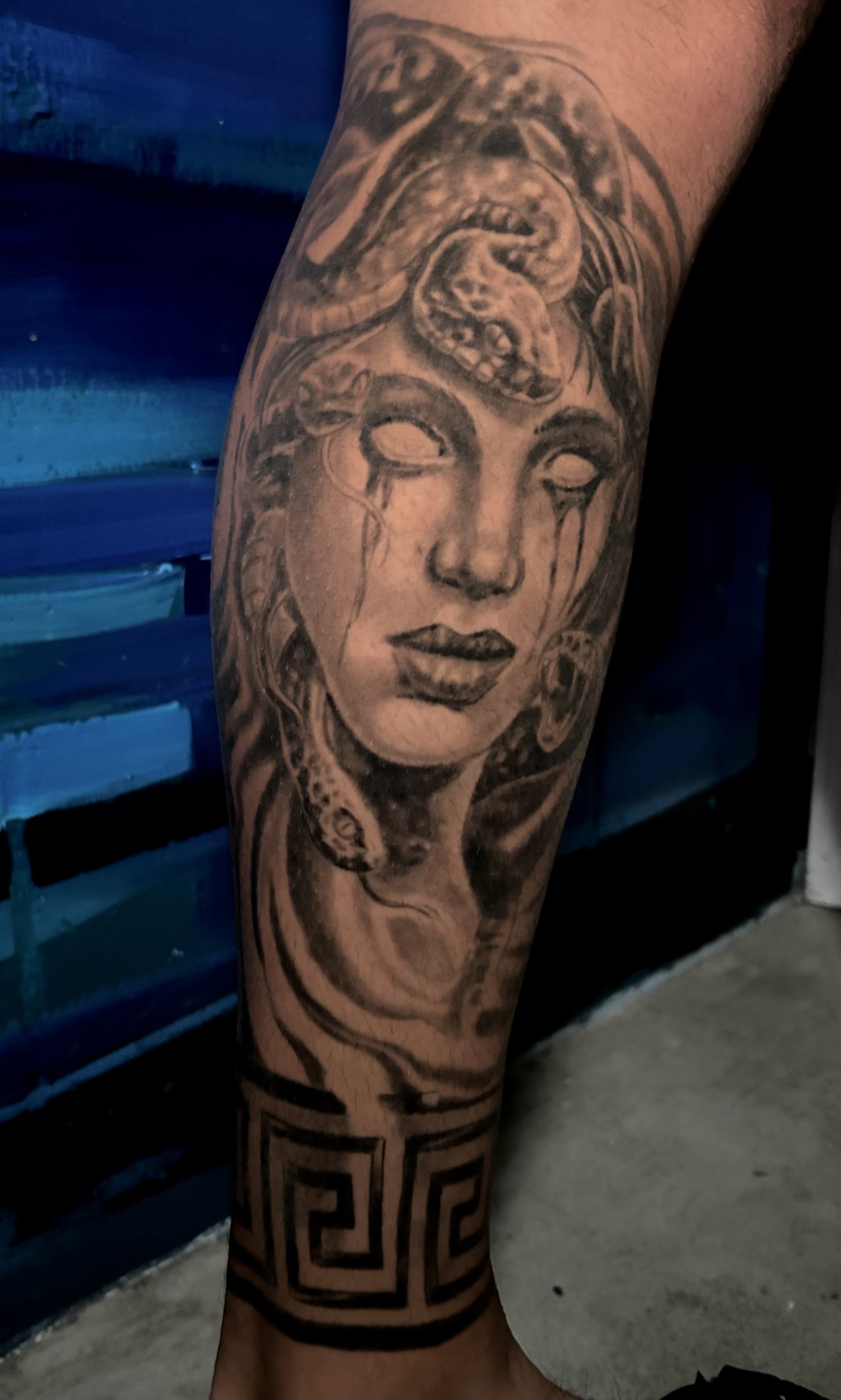 Tattoo of Medusa with snakes and Greek pattern. Tattoo by Brett Guerra.