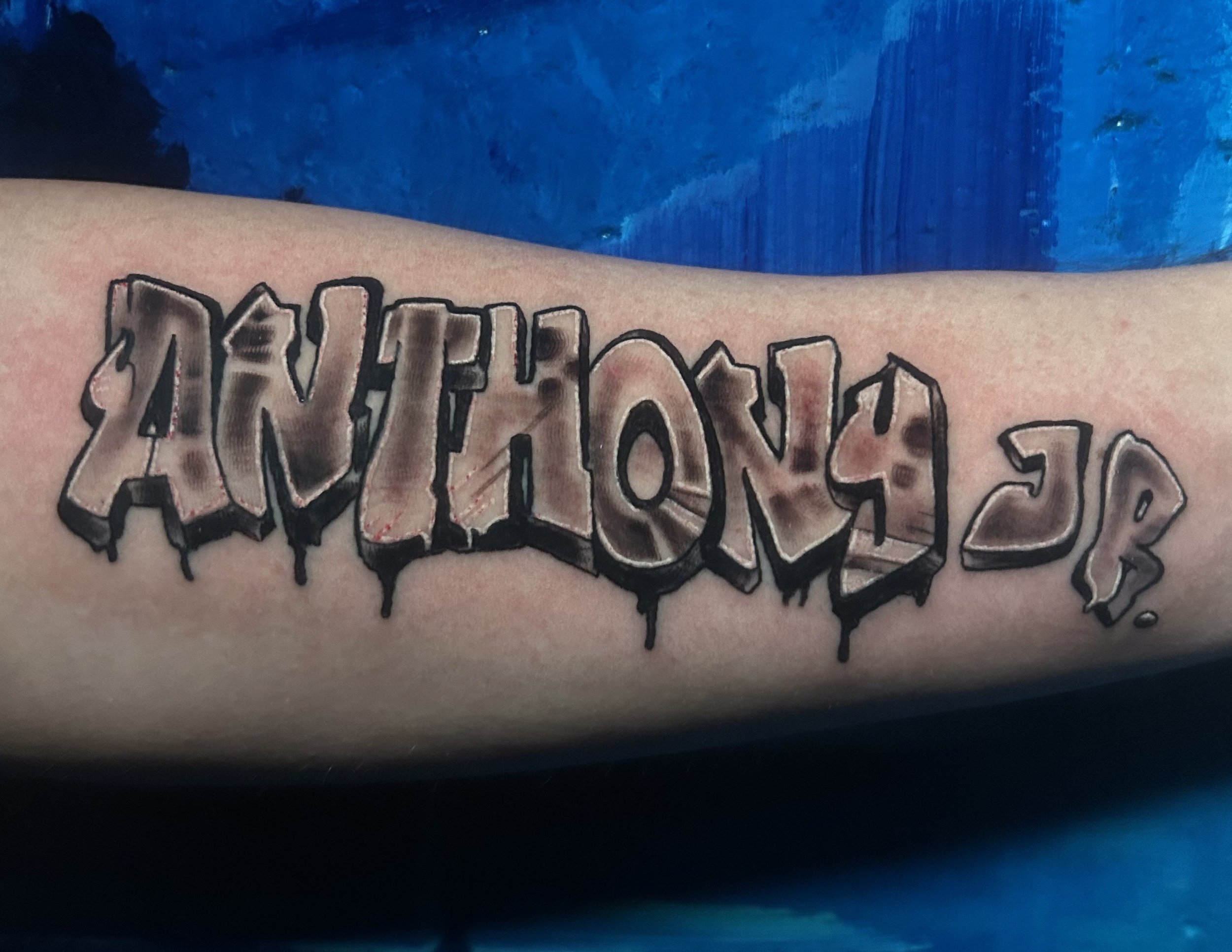 Tattoo of 'Anthony Jr.' in graffiti style on forearm. Tattoo by Brett Guerra.