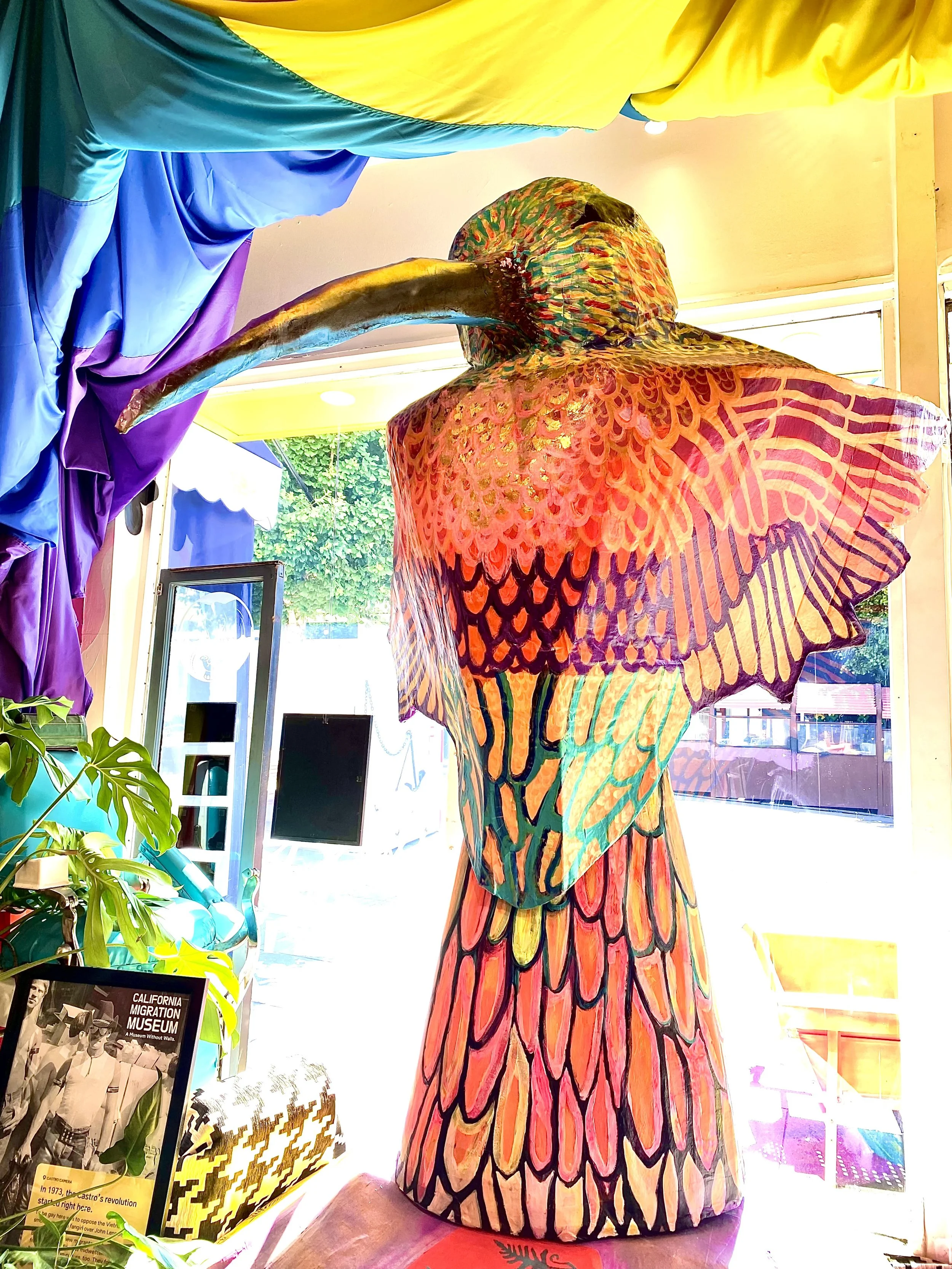 HUITZILIN paper mache hummingbird in multiple bright colors.