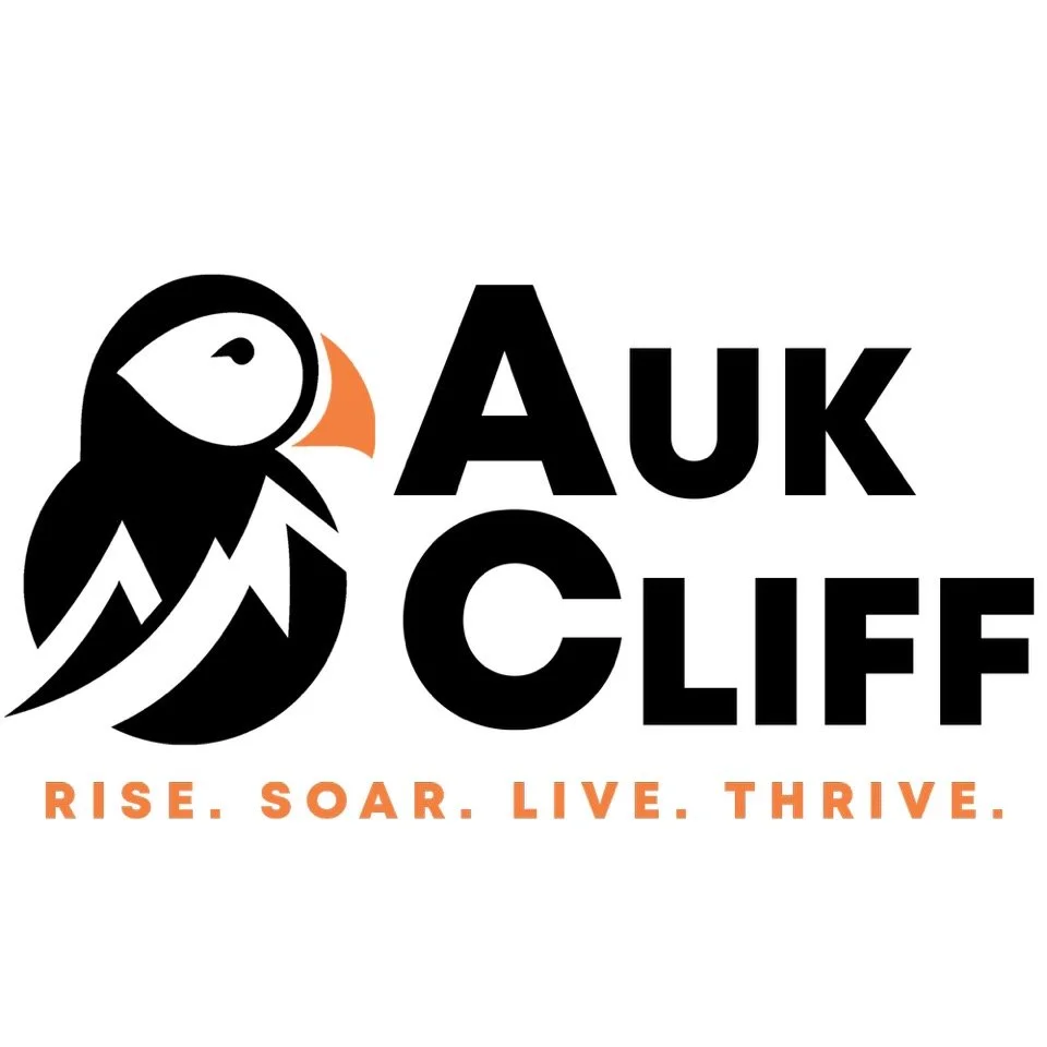 Logo of Auk Cliffs with an abstract puffin bird illustration and the words 'Auk Cliffs' in bold black letters, and the tagline 'Rise. Soar. Live. Thrive.' in orange.