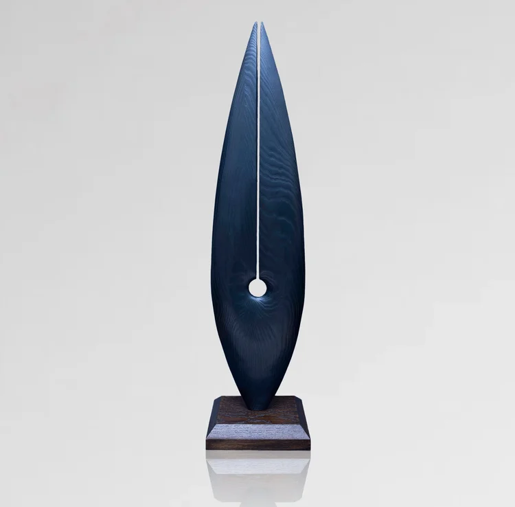 Shanti, a tall midnight-blue carved sculpture with a central opening