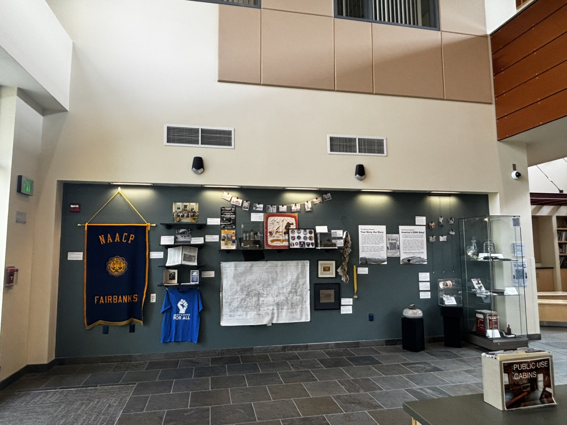 "The Alaskan Blonde" book is in the glass cabinet - and some photos are on the wall - as part of the "Memory Museum" exhibit celebrating 250 Years of America display at the Morris Thompson Center in Fairbanks.