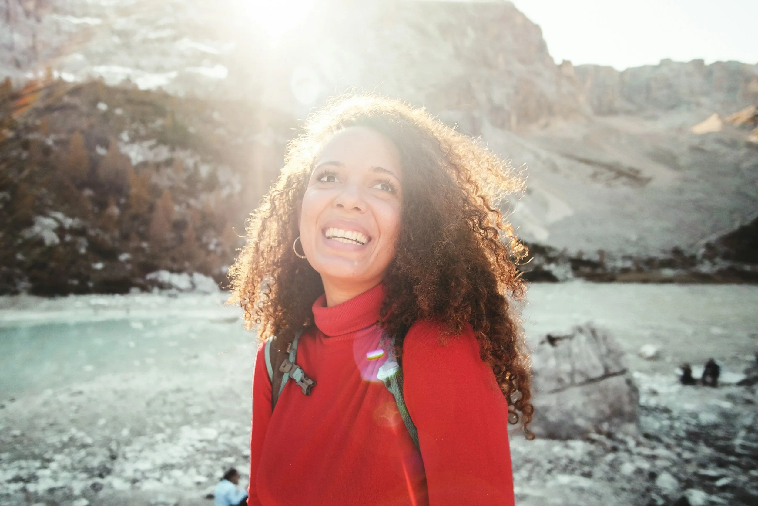 Mature woman with luminous natural skin, visible expression lines, and a healthy vibrant complexion