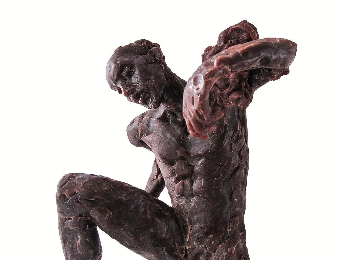 wax figure crouching and carrying something