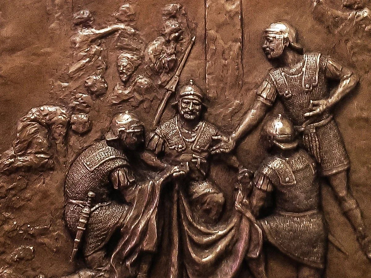 bronze relief sculpture of crucifixion scene