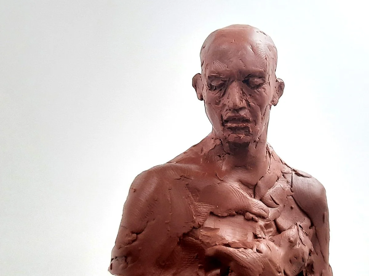 oil clay figure sculpture looking downward