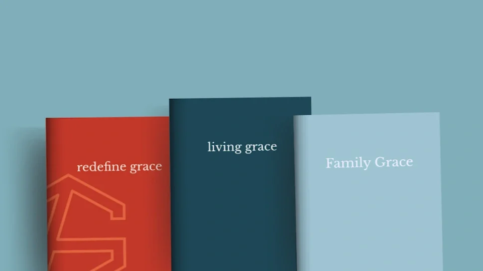 Lecture slide titled 'Grace Groups' featuring a subtitle about a small group experience for mental and emotional resilience, with office supplies like notebooks and a cup on a desk.
