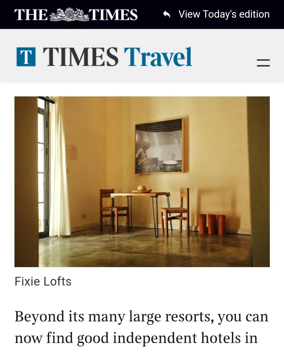Screenshot of a Times Travel article featuring Fixie Lofts with a minimalist interior design in Zona Colonial Santo Domingo.