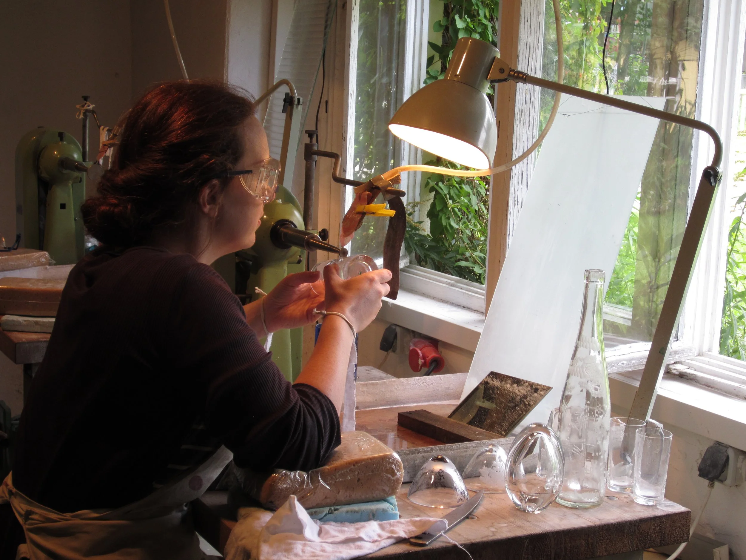 Woman engraving glass on a lathe