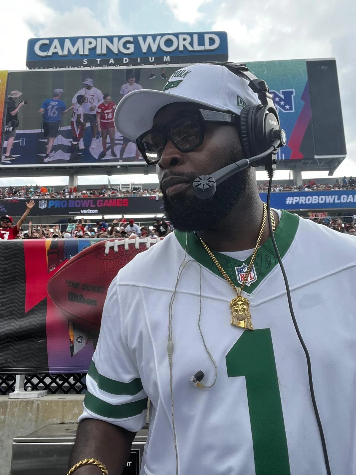 “New York Jets DJ Jon Blak performing live at an NFL Pro Bowl Games stadium.”