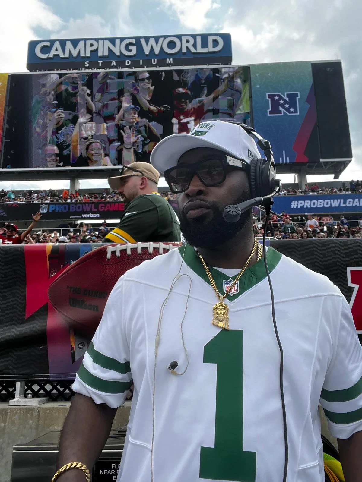 “New York Jets DJ Jon Blak performing live at a professional sports event stadium.”