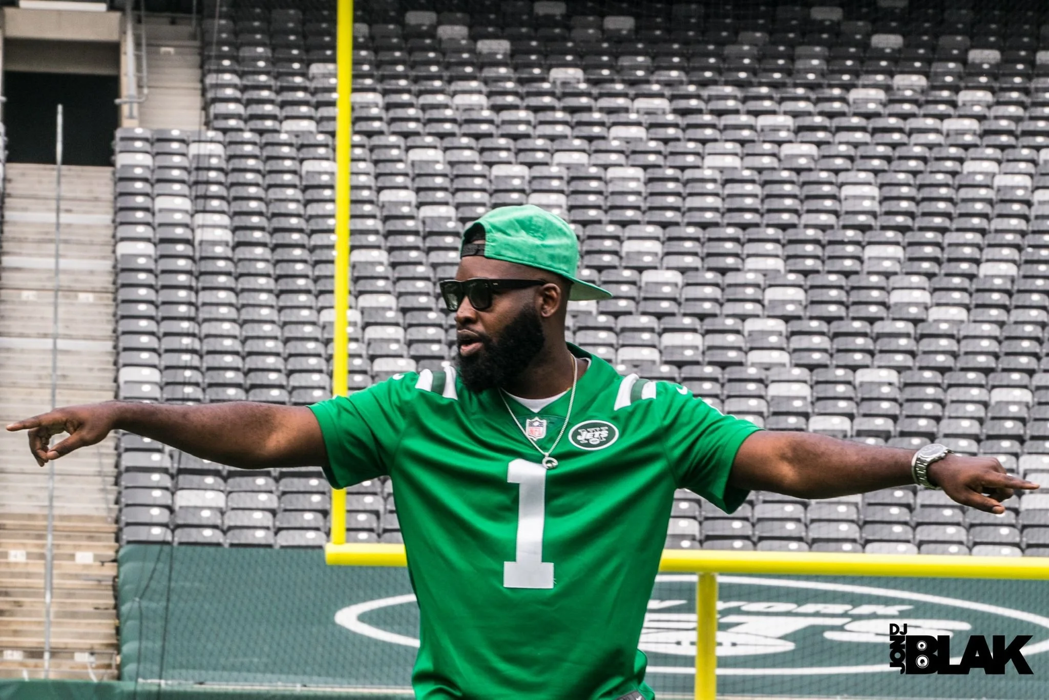 “New York Jets DJ Jon Blak on the field, professional DJ services for corporate and sports events in NYC.”