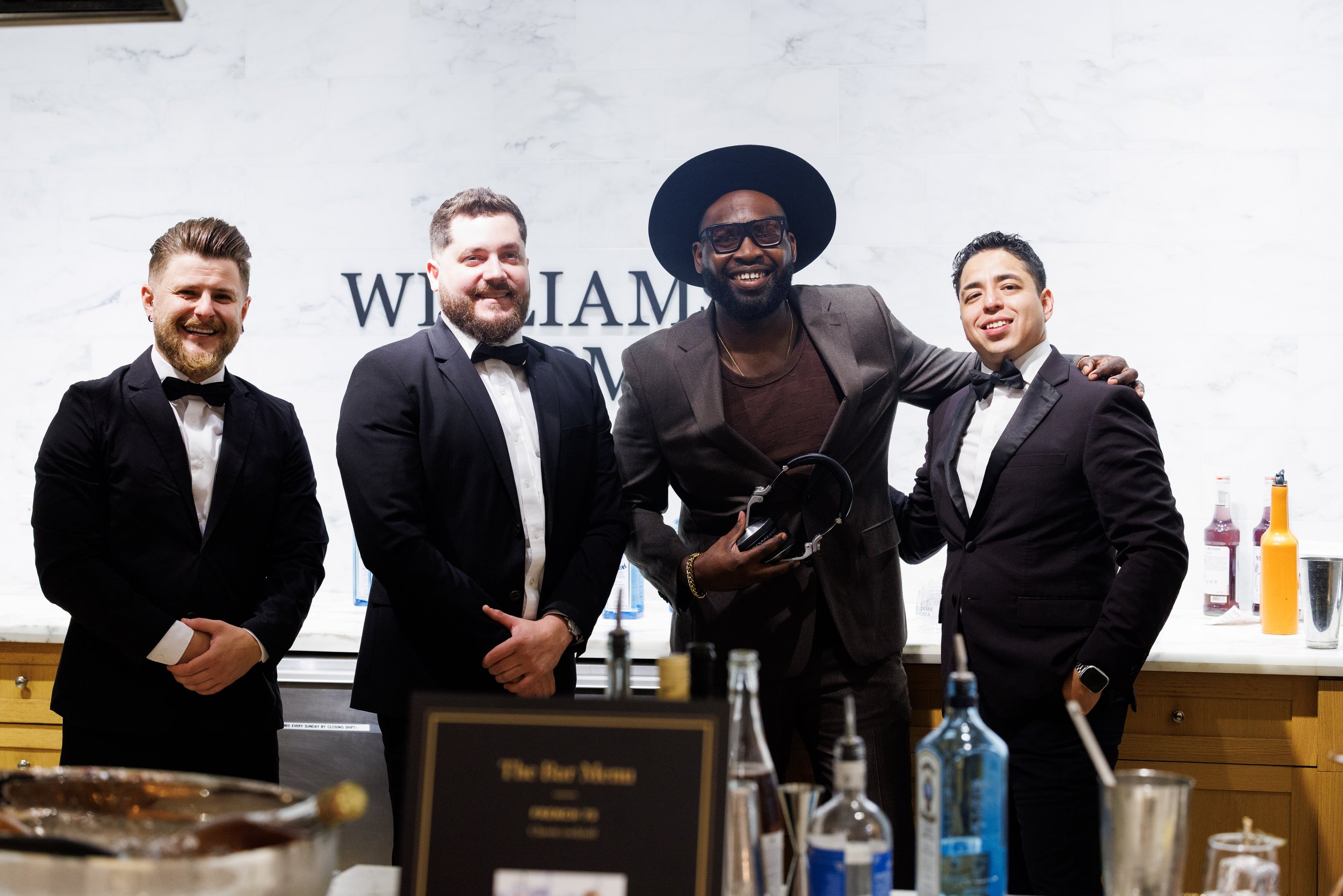 “NYC Wedding DJ & MC DJ Jon Blak posing with event staff at an upscale corporate event, showcasing professional DJ services for weddings, corporate events, and sports events in New York City.”