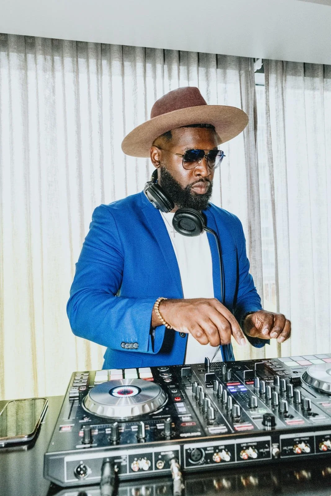 “NYC Wedding DJ & MC DJ Jon Blak mixing music on a professional DJ controller, providing high-end DJ services for weddings, corporate events, and sports events in New York City.”