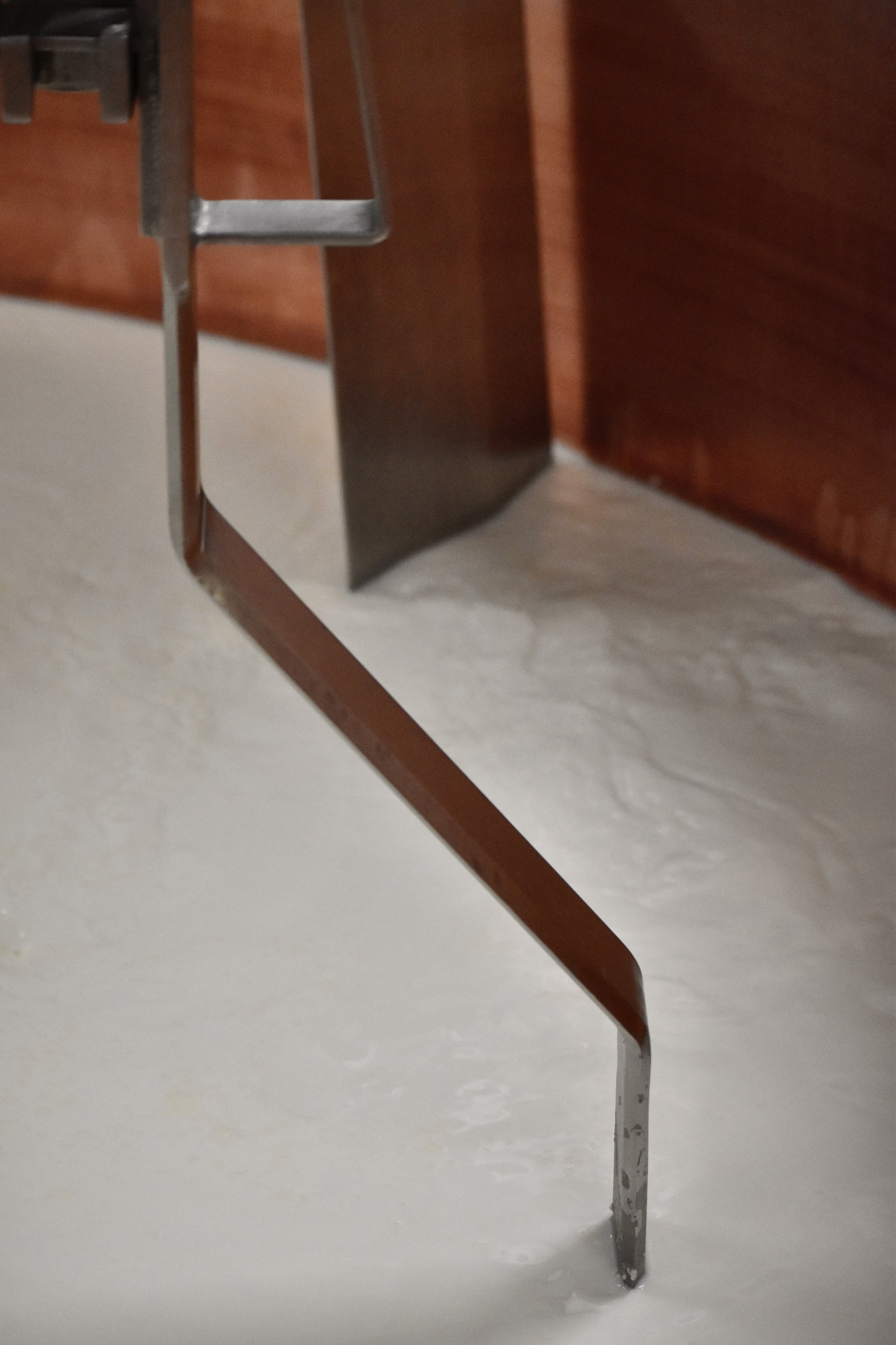  Close up of milk in a copper cheesemaking vat 