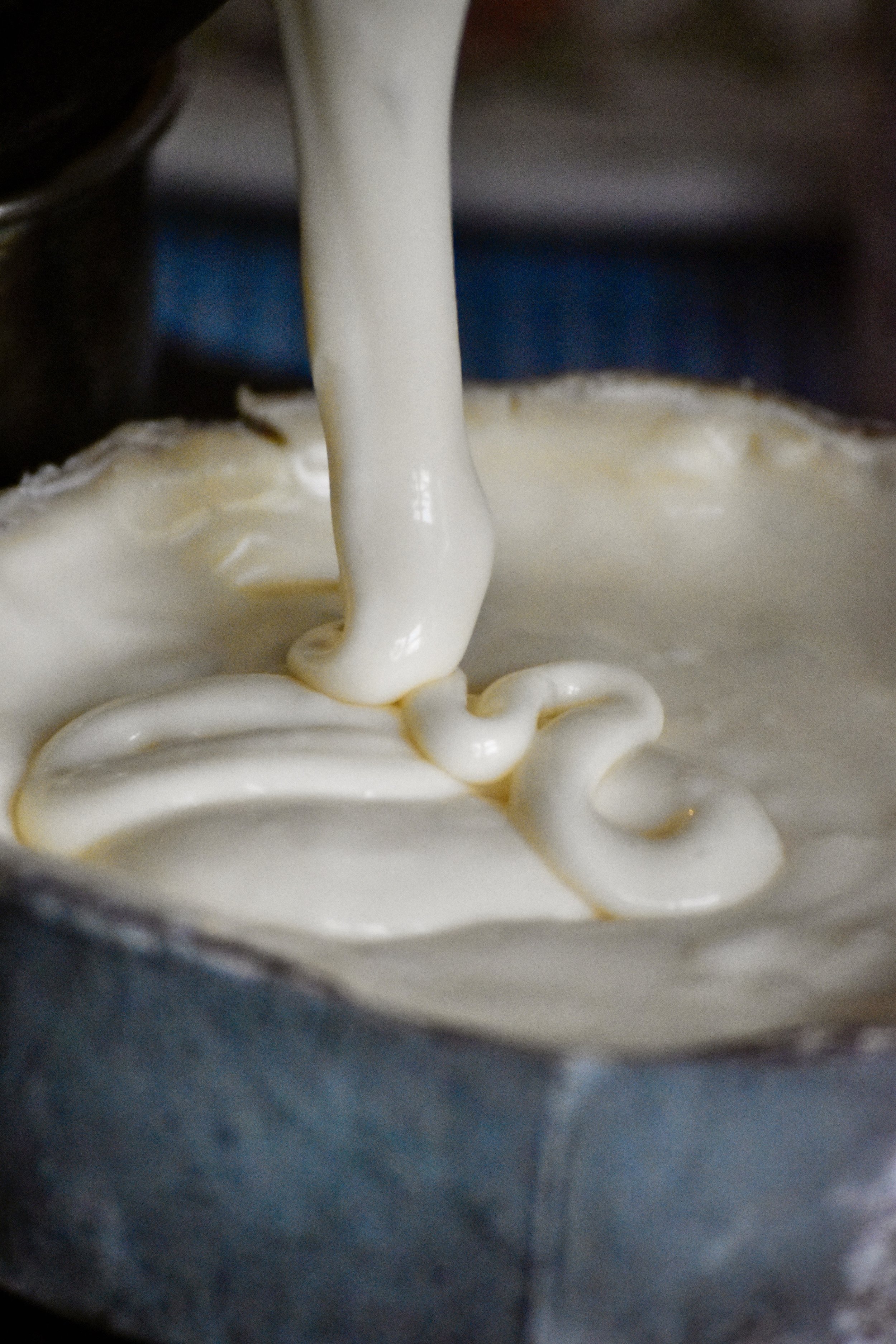  Close-up very ripe Harbison paste as it falls off a spoon into thick swirls 