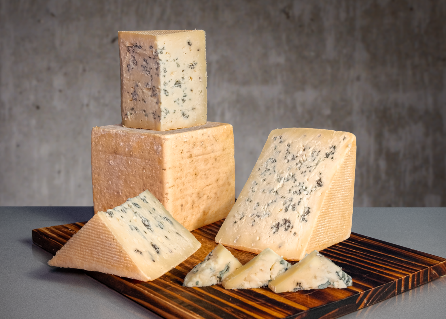 a cubic blue cheese with rust colored rind displayed in cut pieces