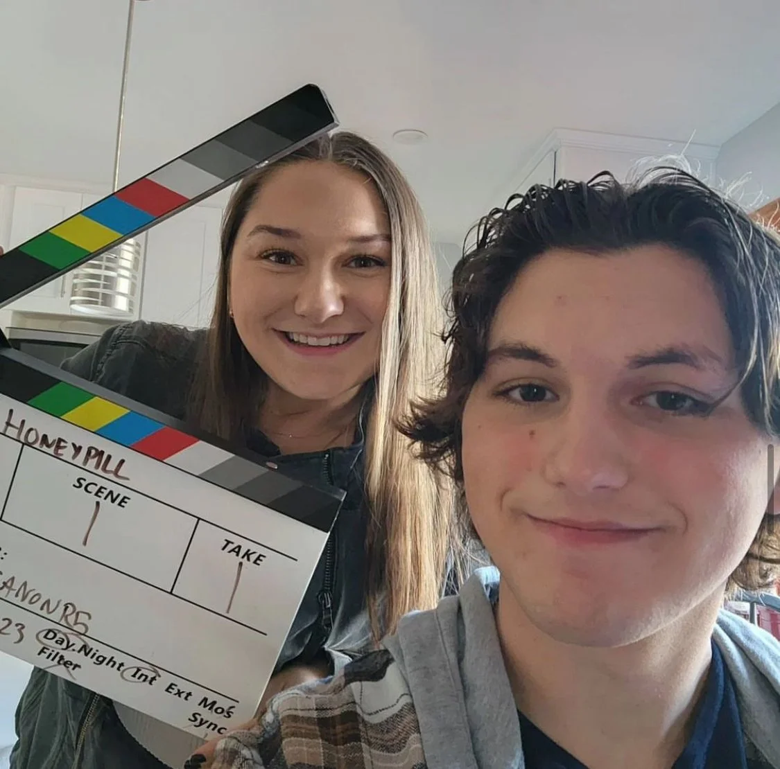 Behind the scene on the short film "HoneyPill" where Abby Marcus poses with the clapper that states "Scene 1 Take 1".