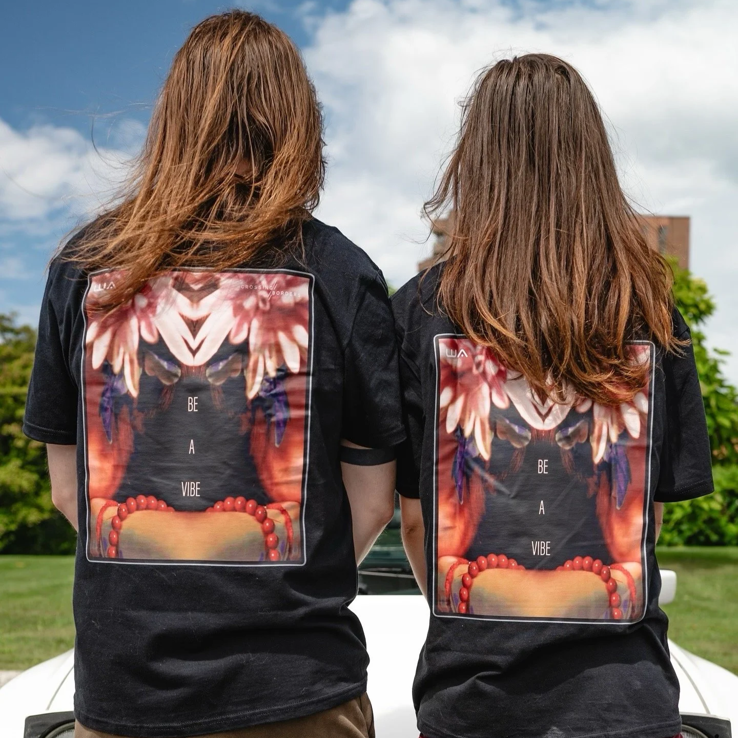Black t-shirt featuring a digital artwork of an android with a patterned face in a white hoodie.