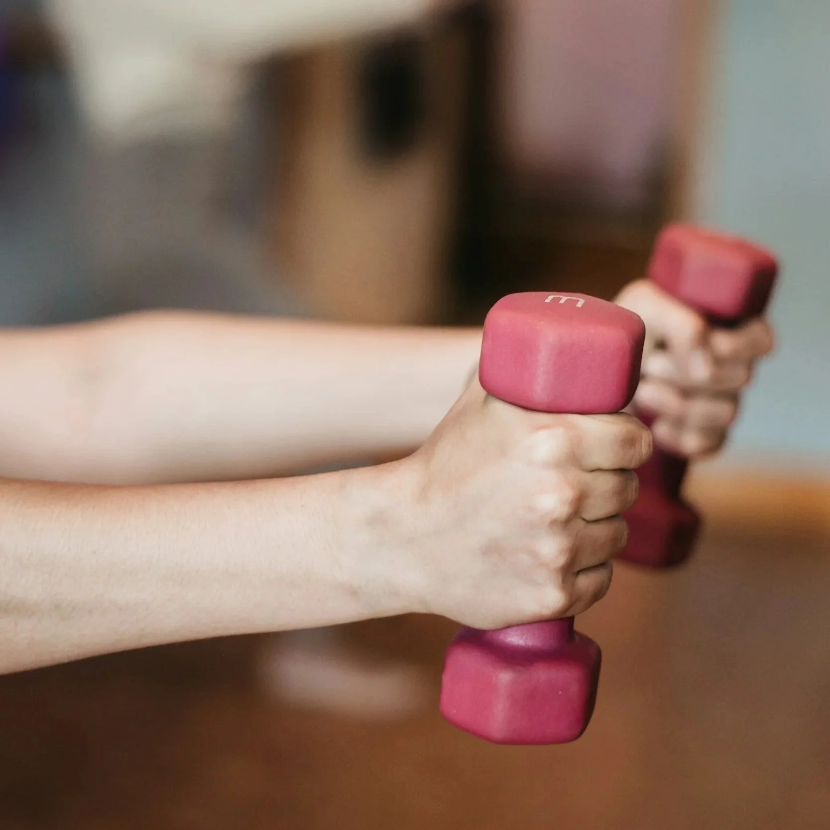 Person holding up 3lb weights