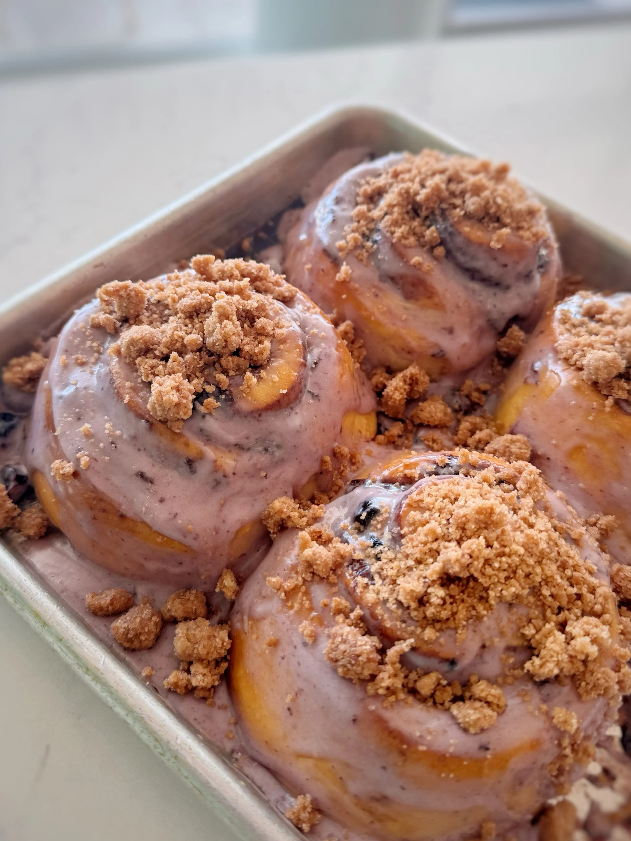 Have you ever seen a more beautiful set of buns in all your life? 😍

Our specialty roll for the month of May is the Blueberry Cobbler Roll: our classic cinnamon bun with the addition of homemade blueberry jam, blueberry cream cheese frosting, and ci