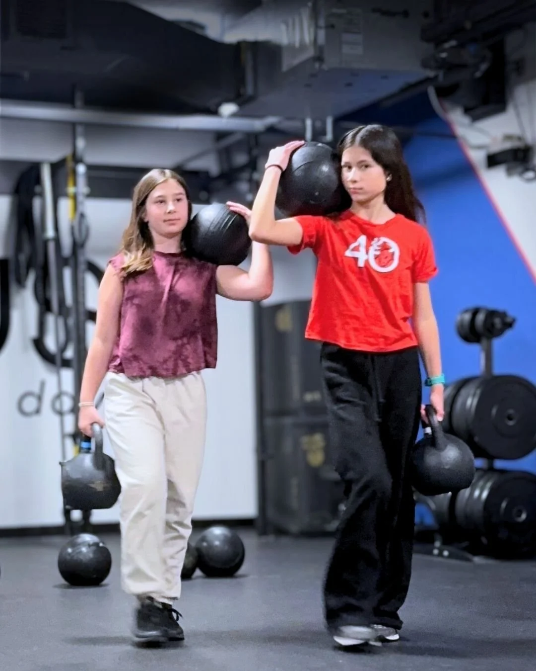 two girls participating in youth strength training and camp
