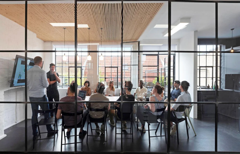 Glass-walled meeting room in the East London studio