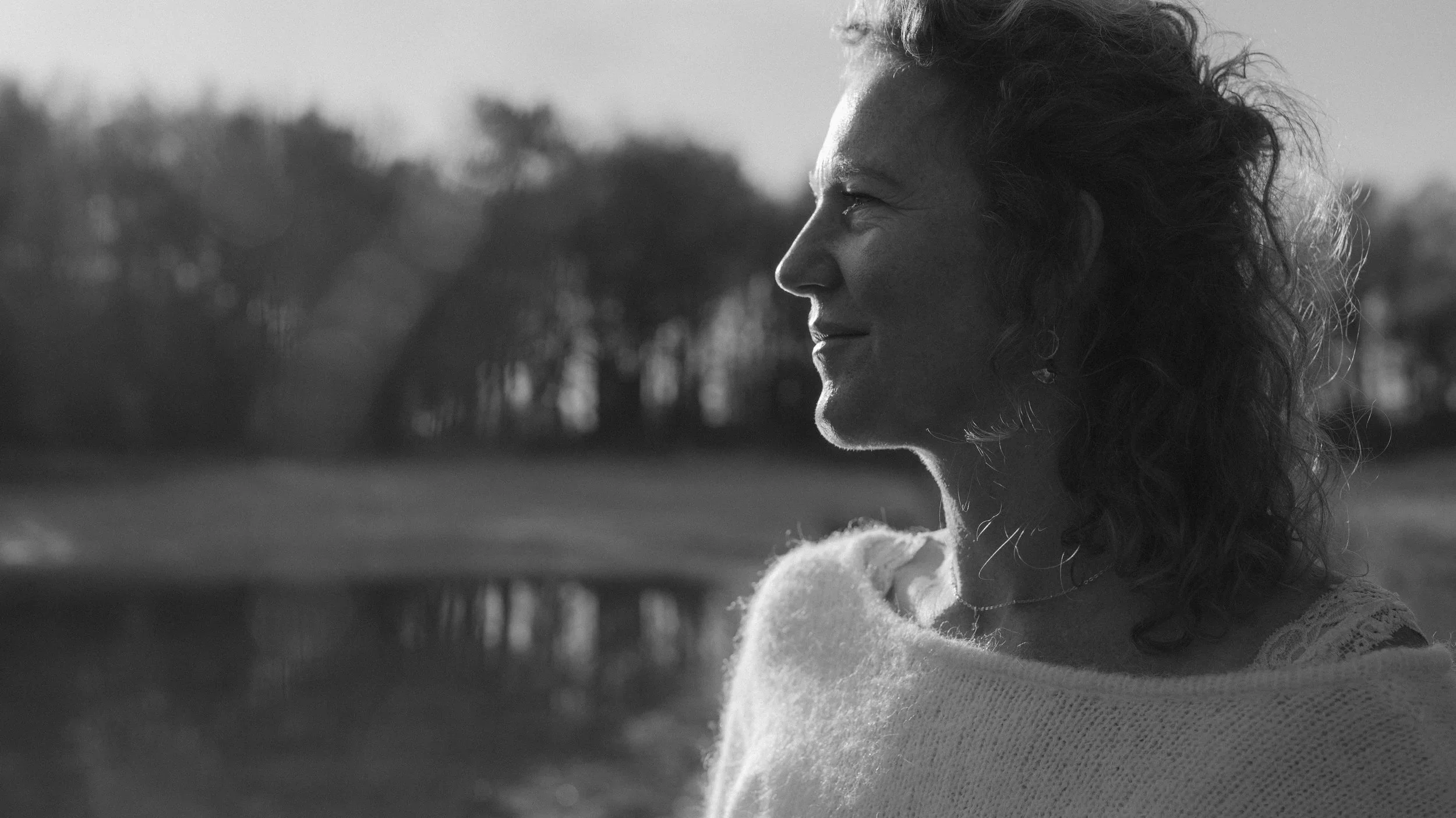 Dromerige foto van een vrouw aan de waterkant in de zon. Personal Branding Fotograaf Assen Drenthe, Branding fotografie, zakelijke foto's, fotoshoot voor je bedrijf.