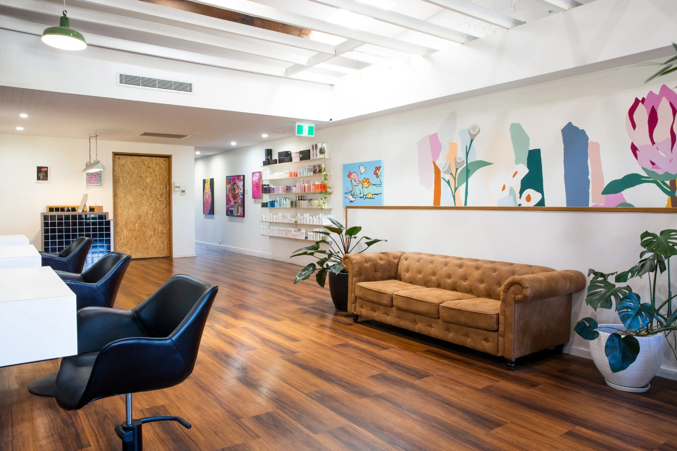 Industrial loft-style boutique salon in Coolangatta featuring exposed beams, modern finishes and an open, light-filled space.