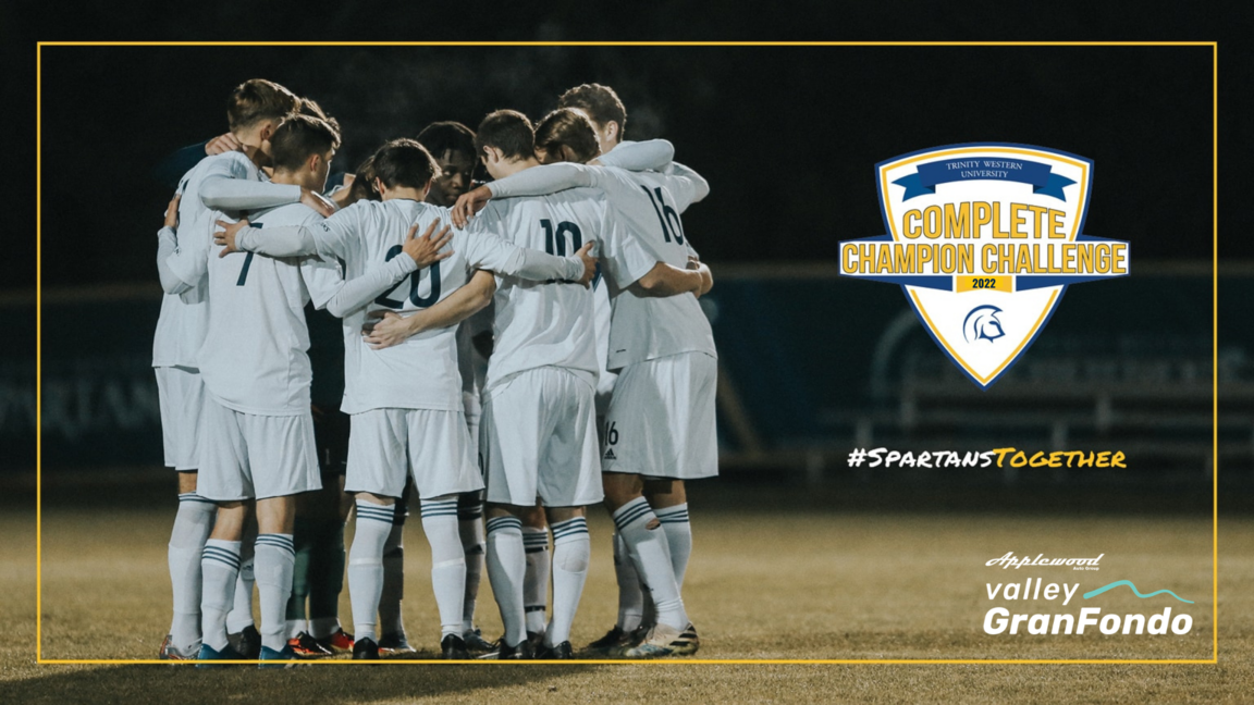 A group for Spartan soccer players have a group huddle on the field