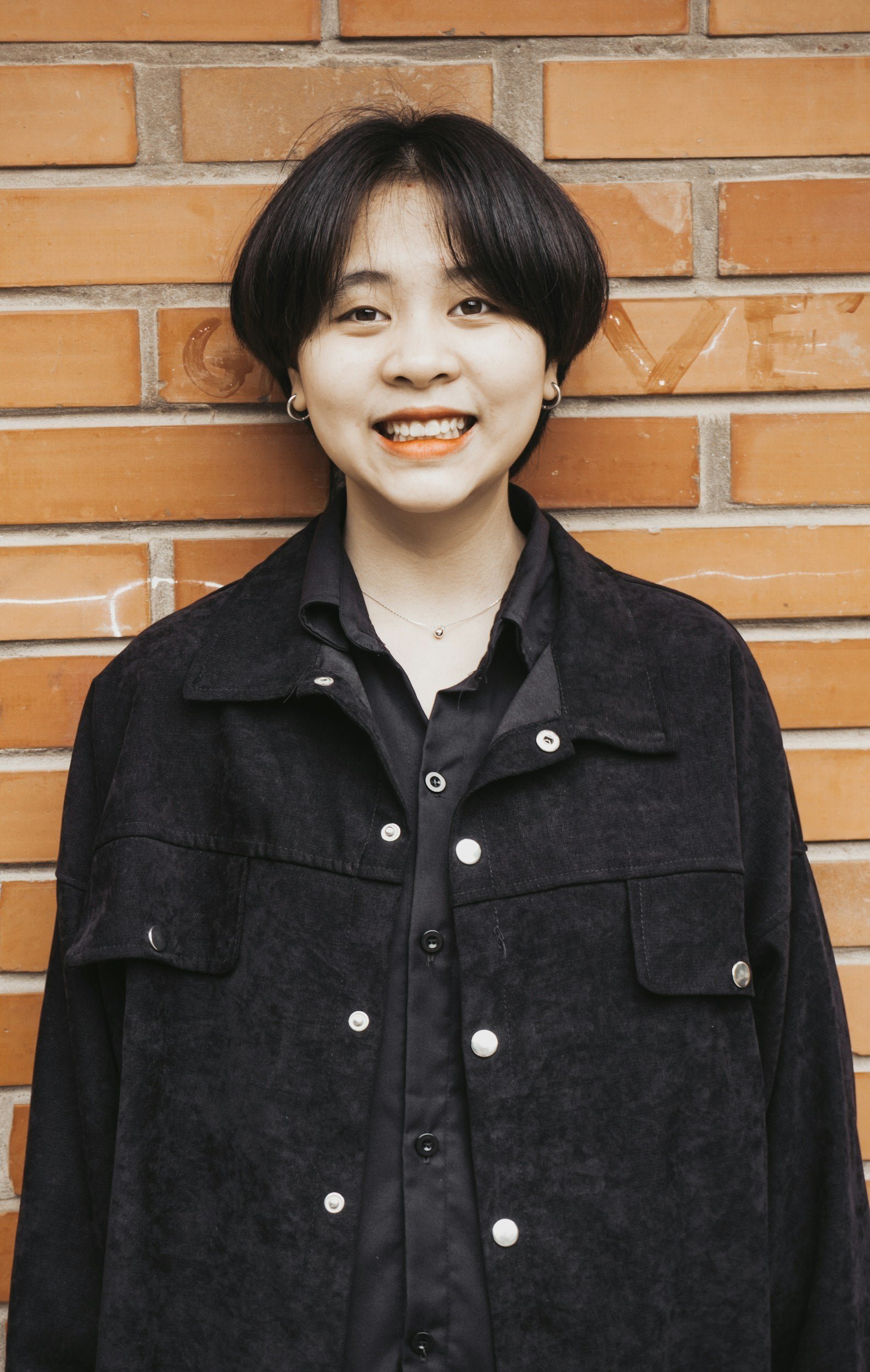 smiling teenager in oversized jean jacket