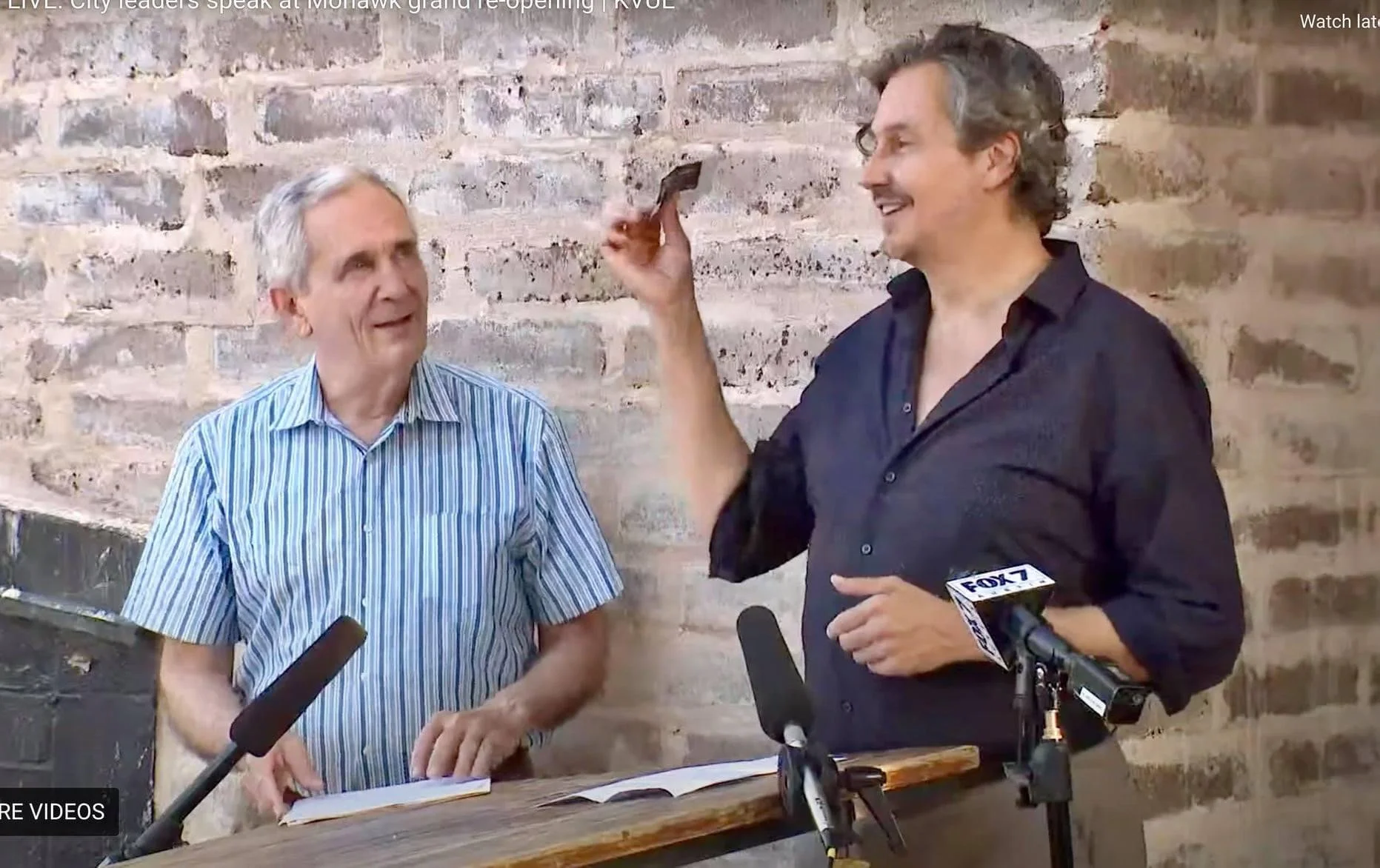Two gentlemen at a press conference.