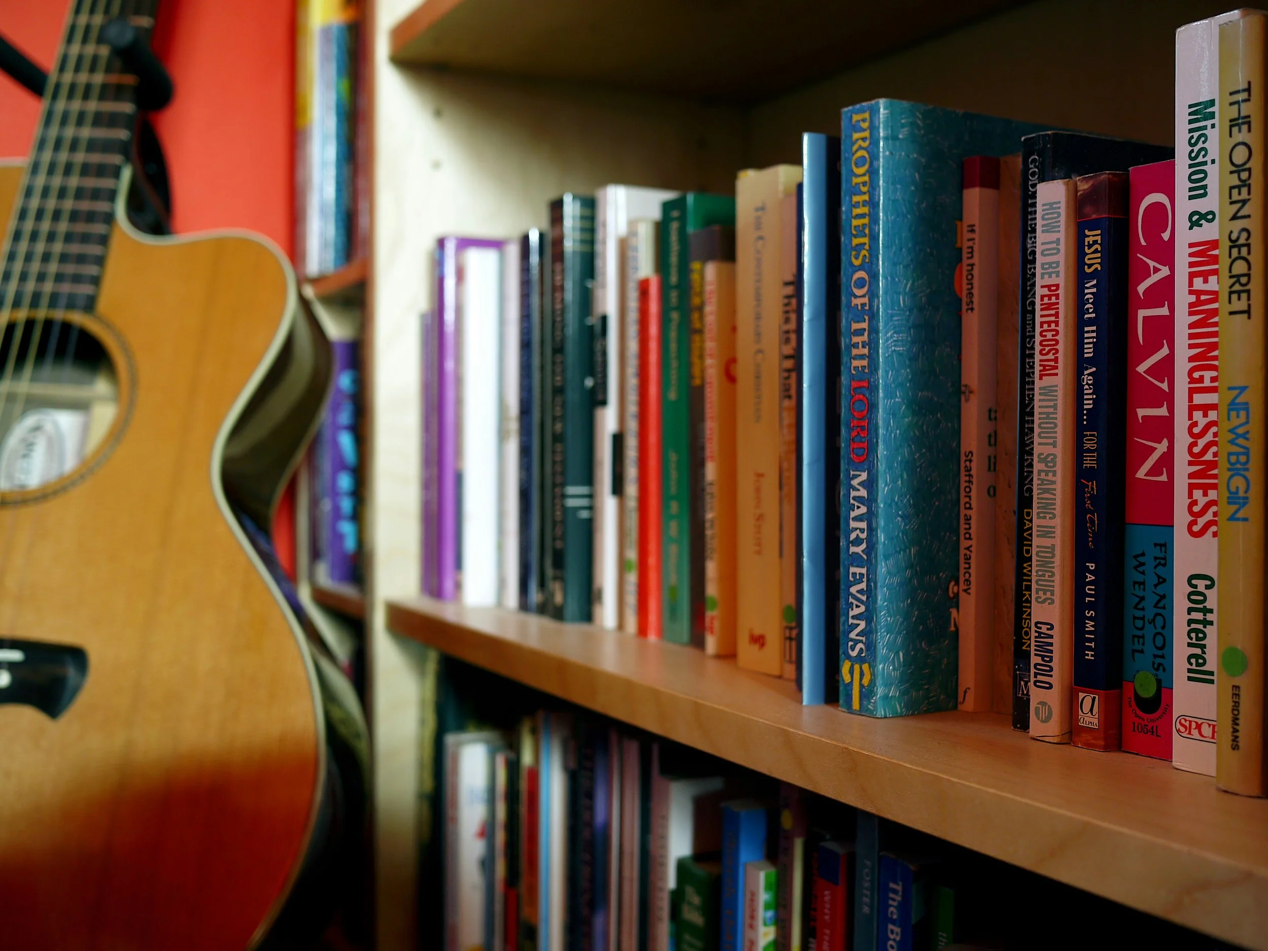 Bookshelves with guitar in foreground