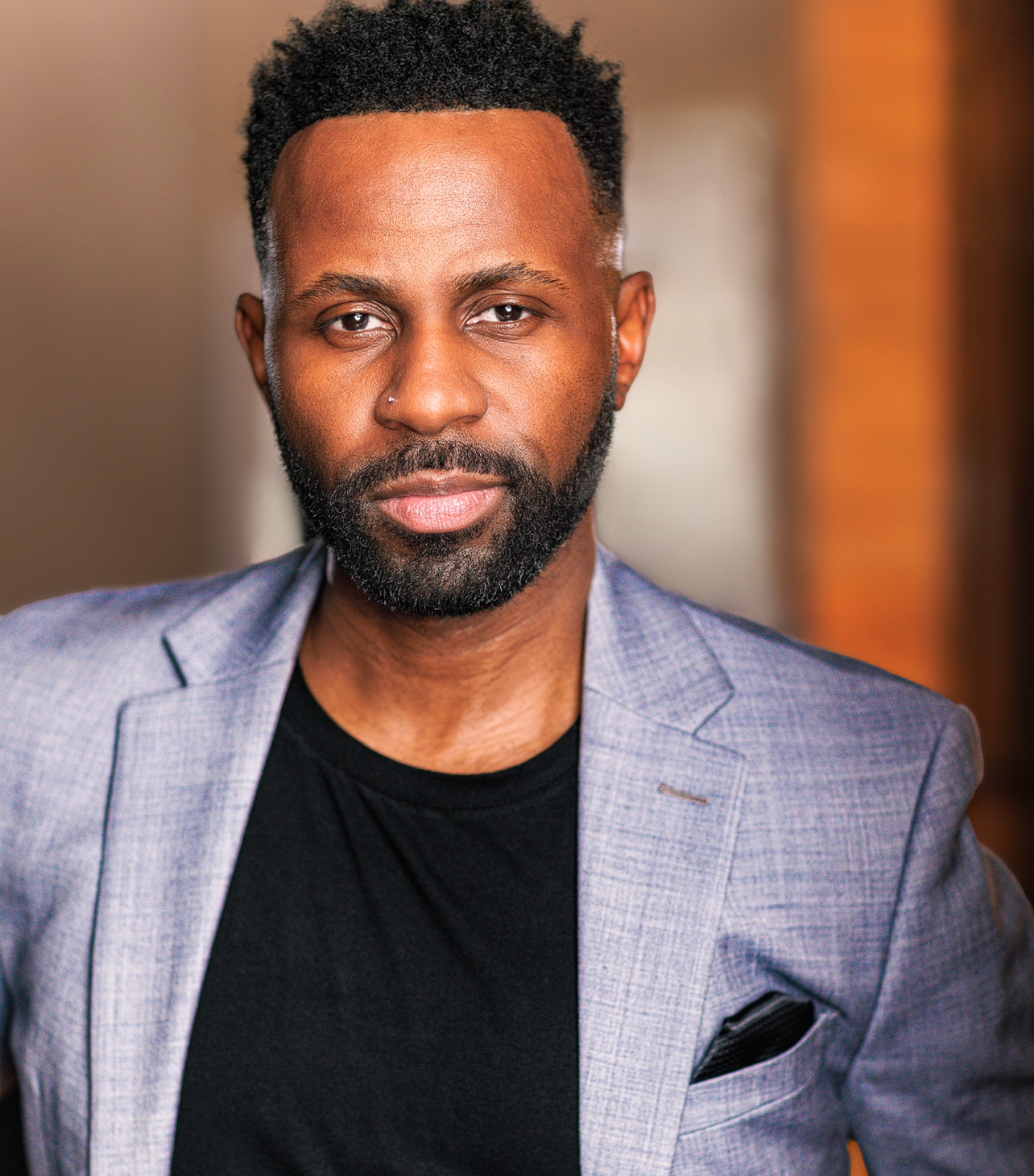 Justin D. Key in a gray blazer for a professional actor headshot.