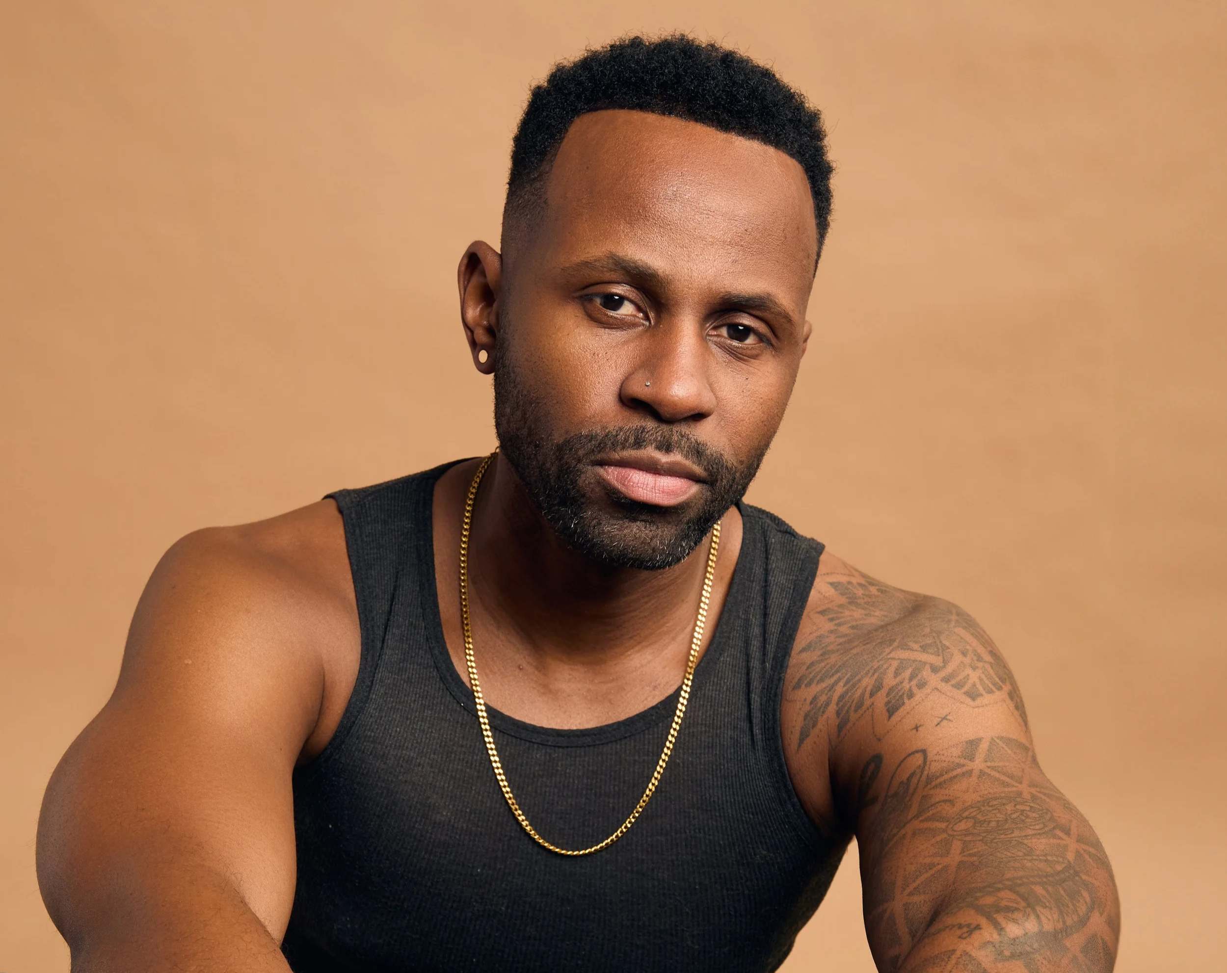 Justin D. Key in a black sleeveless shirt for a professional actor headshot.