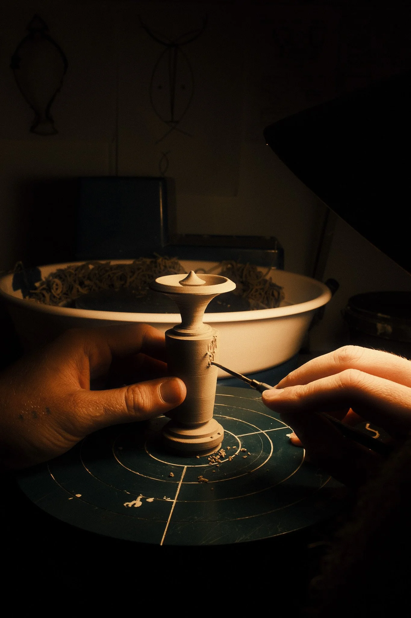 Before finishing trimming I get it off the wheel to carve on it when it is not at its most brittle, to diminish the chances of breakage. 