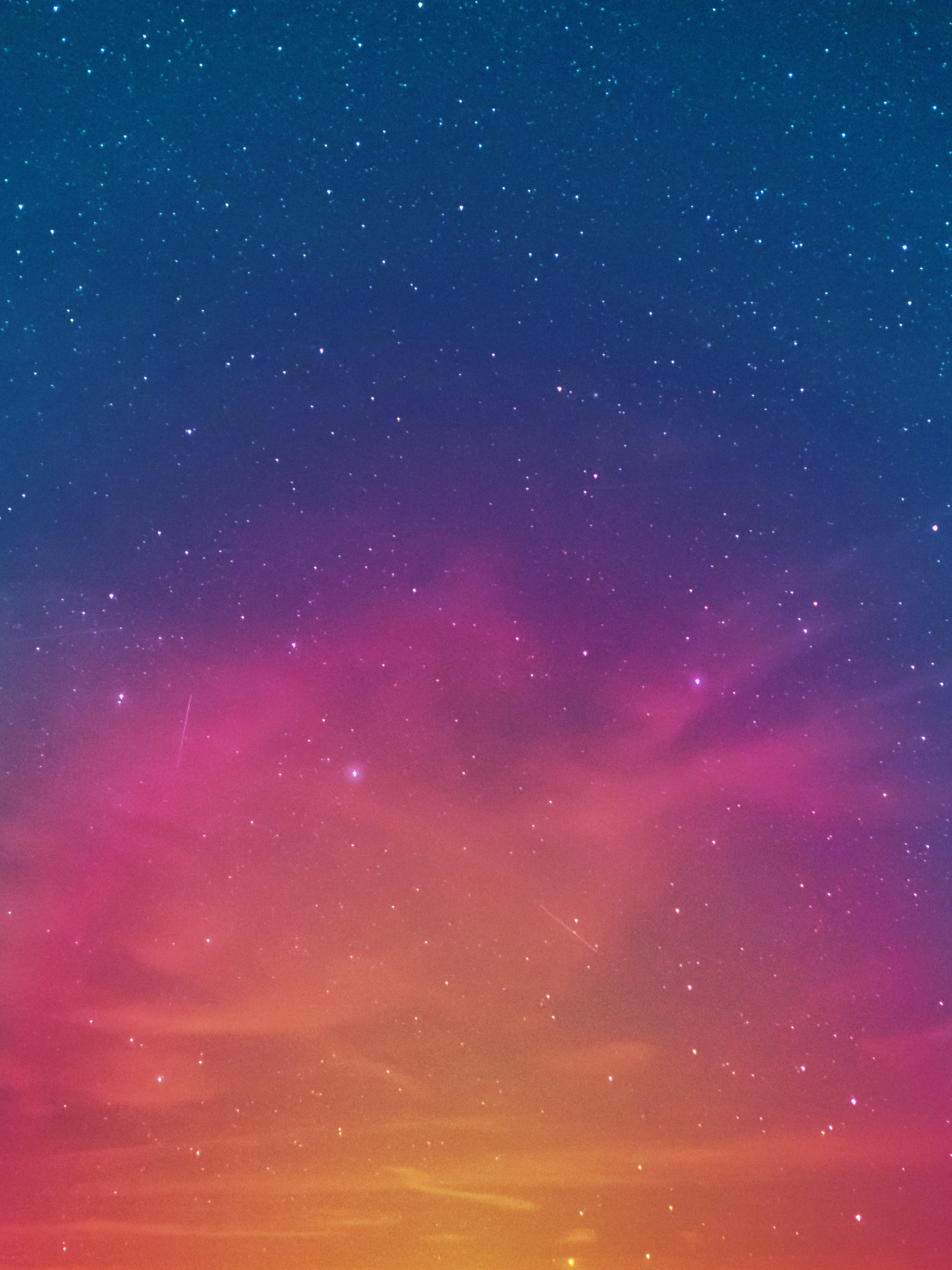 Starry sunset background of navy, purple, pink, and orange fade with white star speckles.