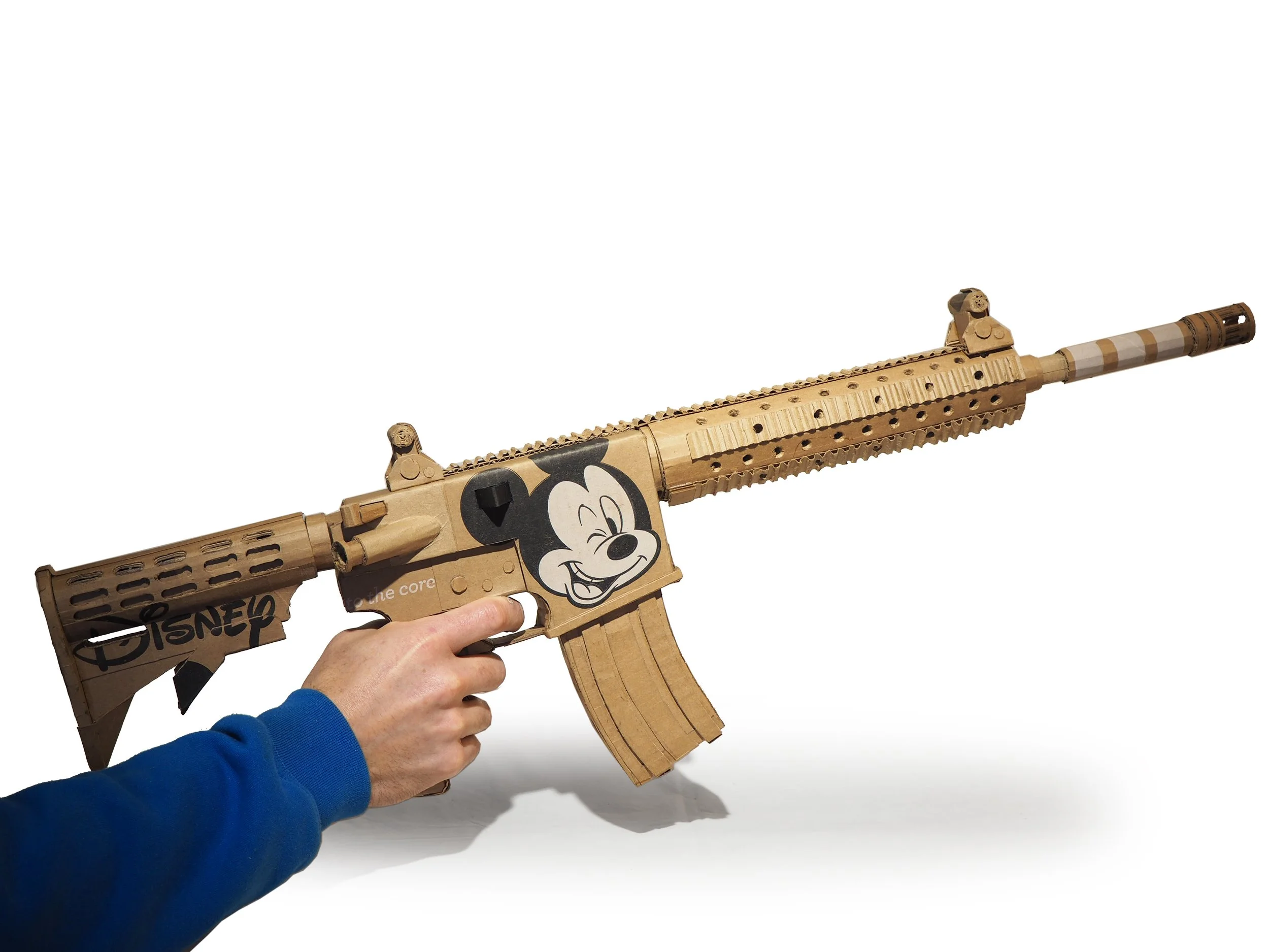 Disney Mickey Mouse satire Florida mass shooting cardboard recycled material art sculpture political action post consumer culture pop art parody