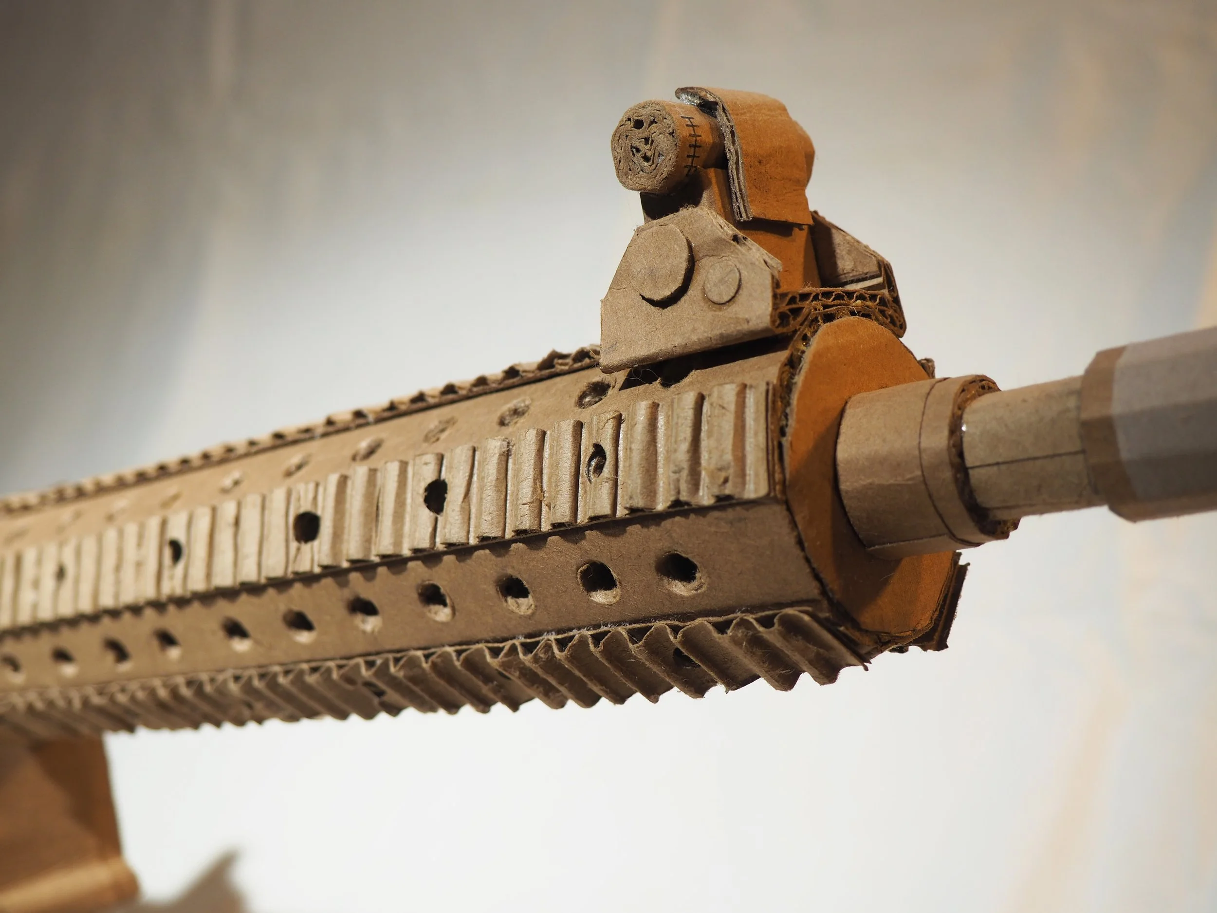 Disney satire Florida mass shooting cardboard recycled material art sculpture political action parody