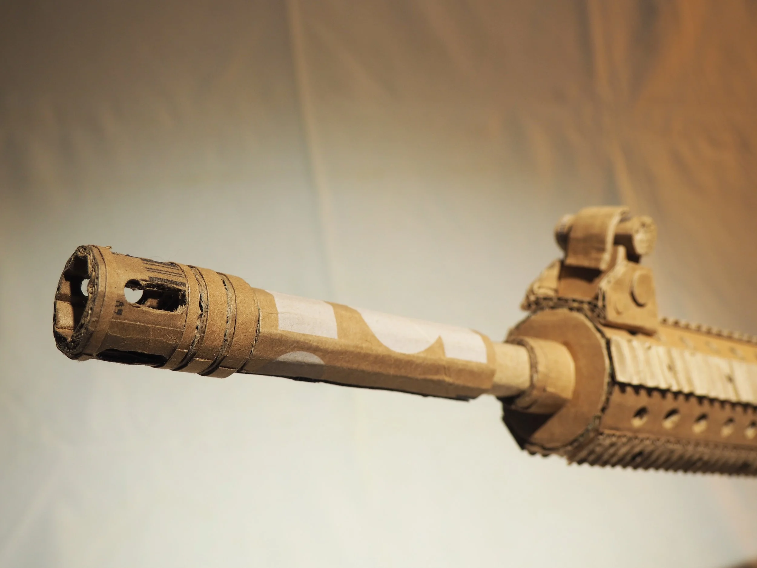 Disney corporate satire Florida mass shooting cardboard recycled material art sculpture political action parody