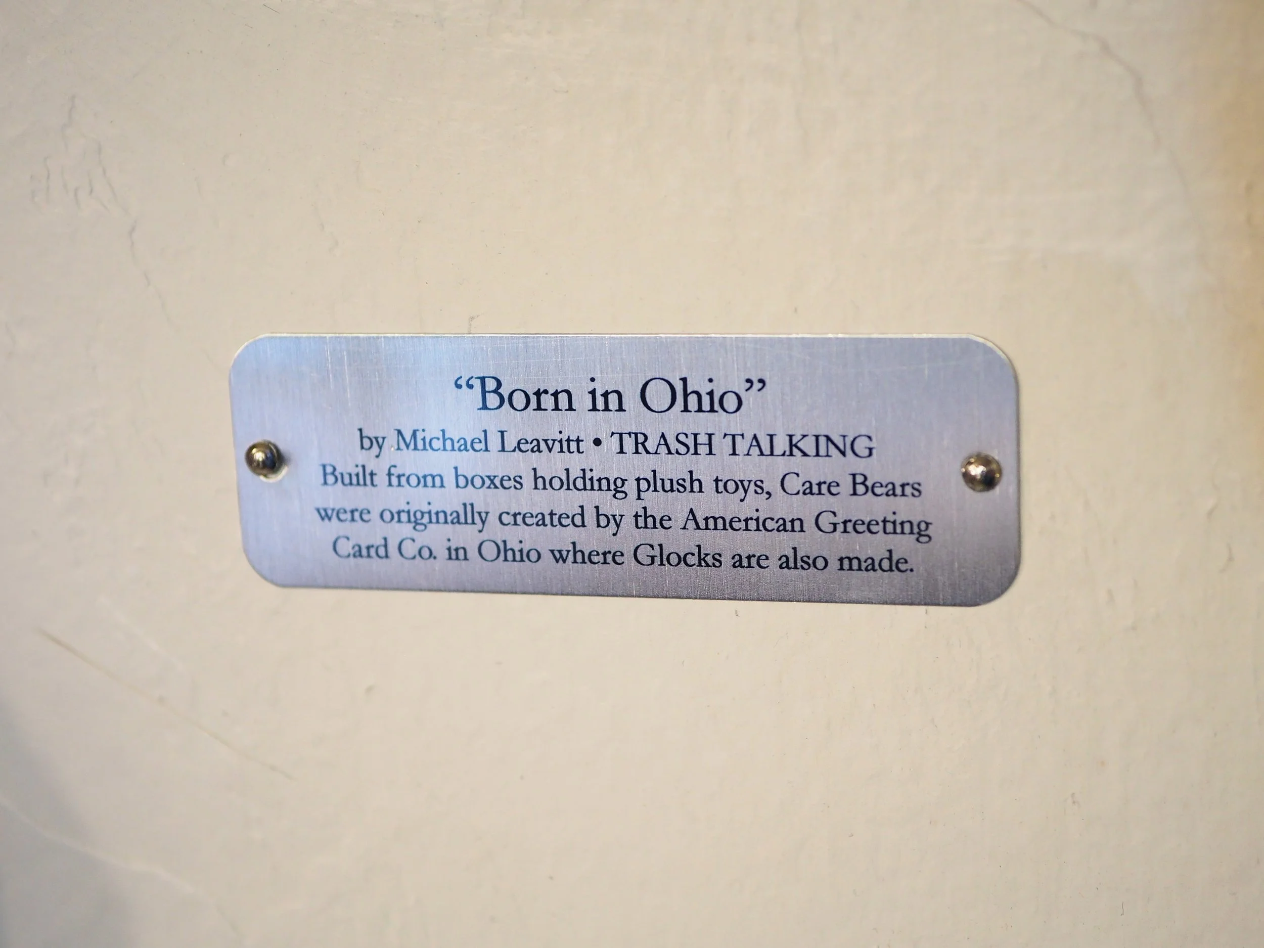 Mass shooting cardboard Care Bears recycled material art sculpture political action satire