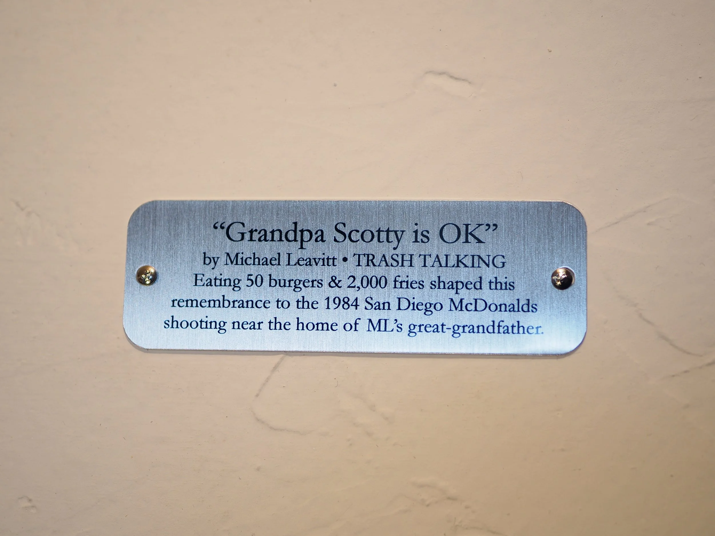 Mass shooting cardboard Uzi recycled material art sculpture political action McDonalds corporate culture parody