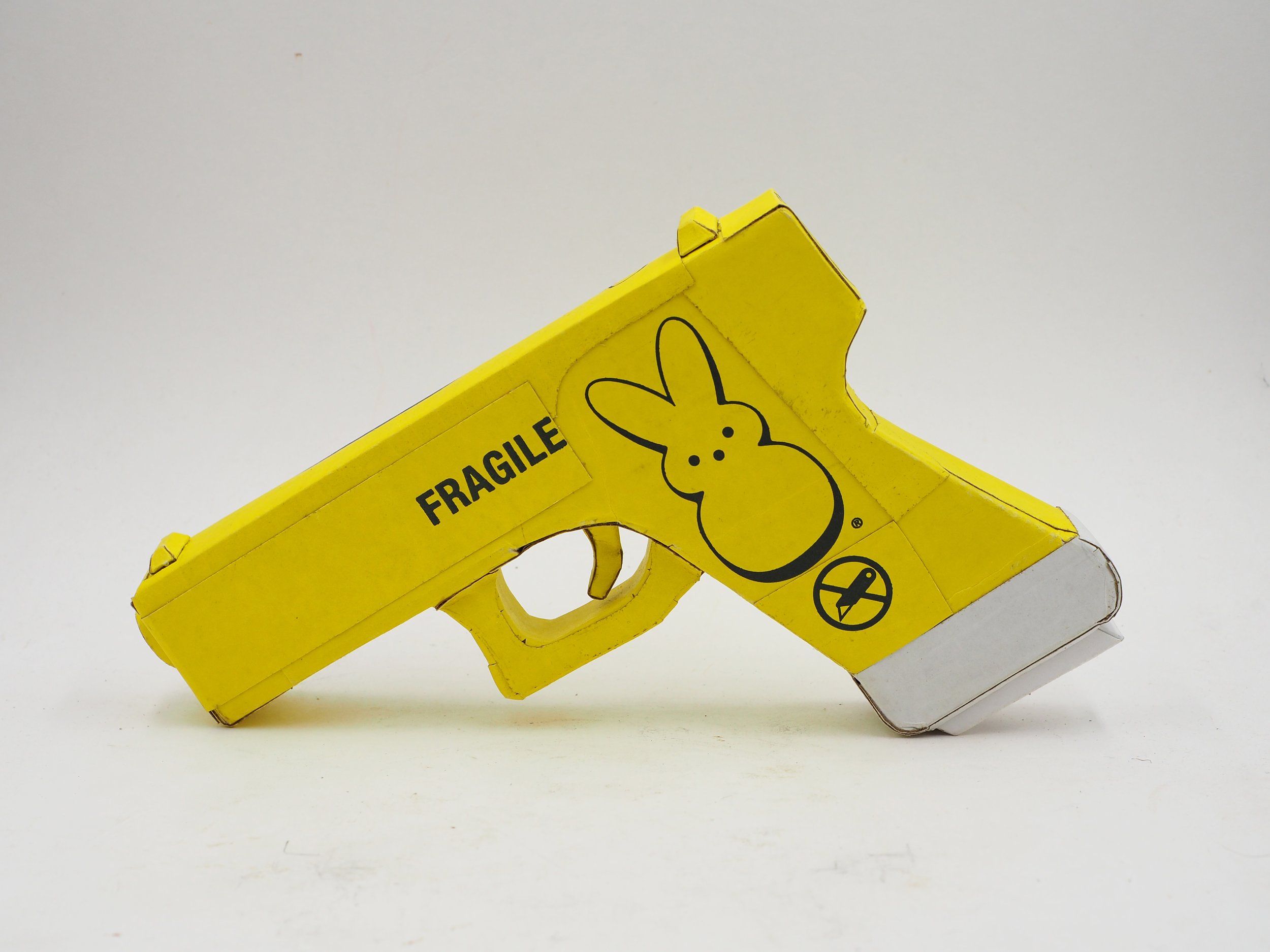Mass shooting yellow marshmallow Easter candy peeps cardboard recycled material art sculpture political action satire