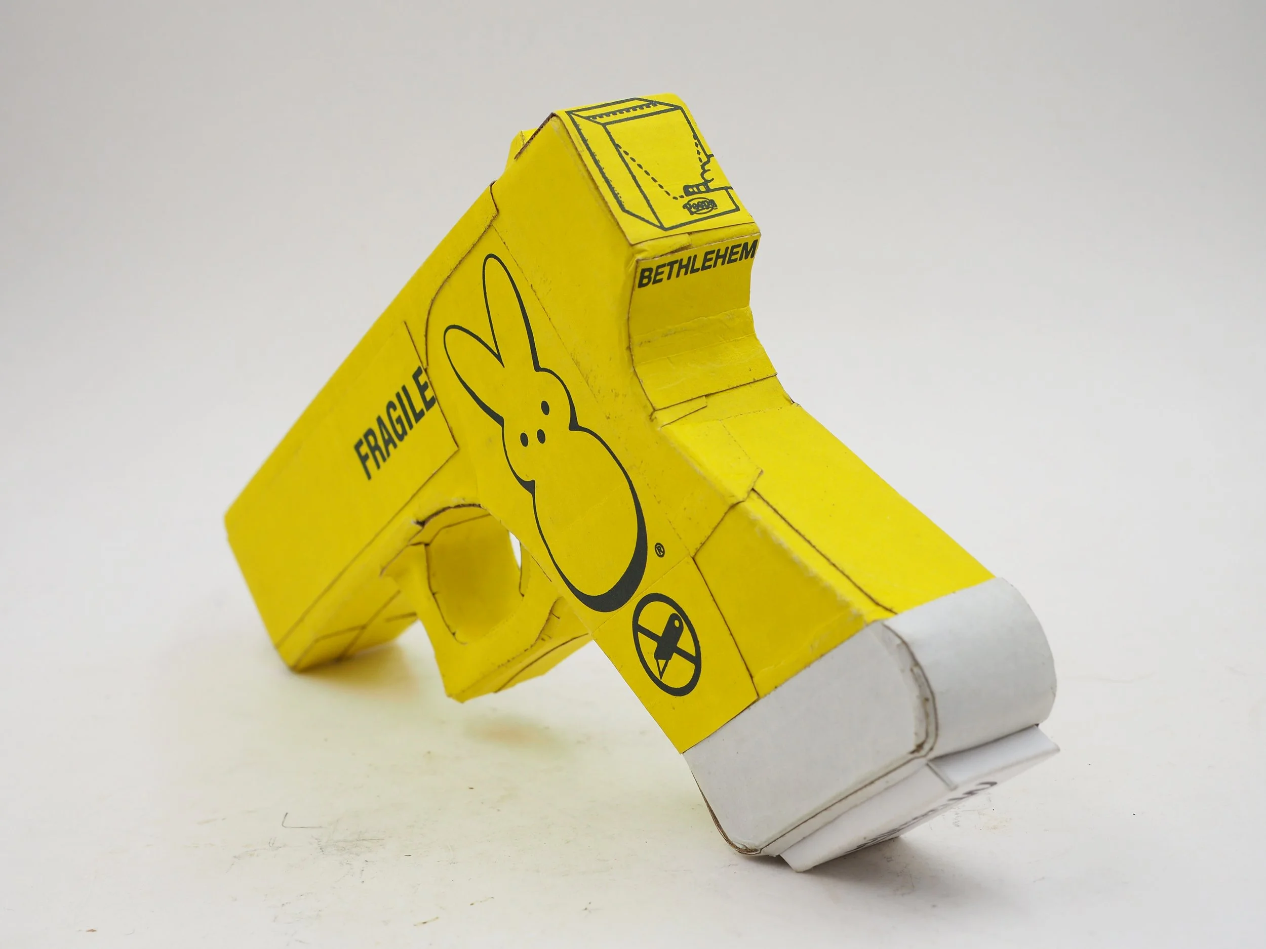Mass shooting yellow marshmallow Easter candy peeps cardboard recycled material art sculpture political action satire